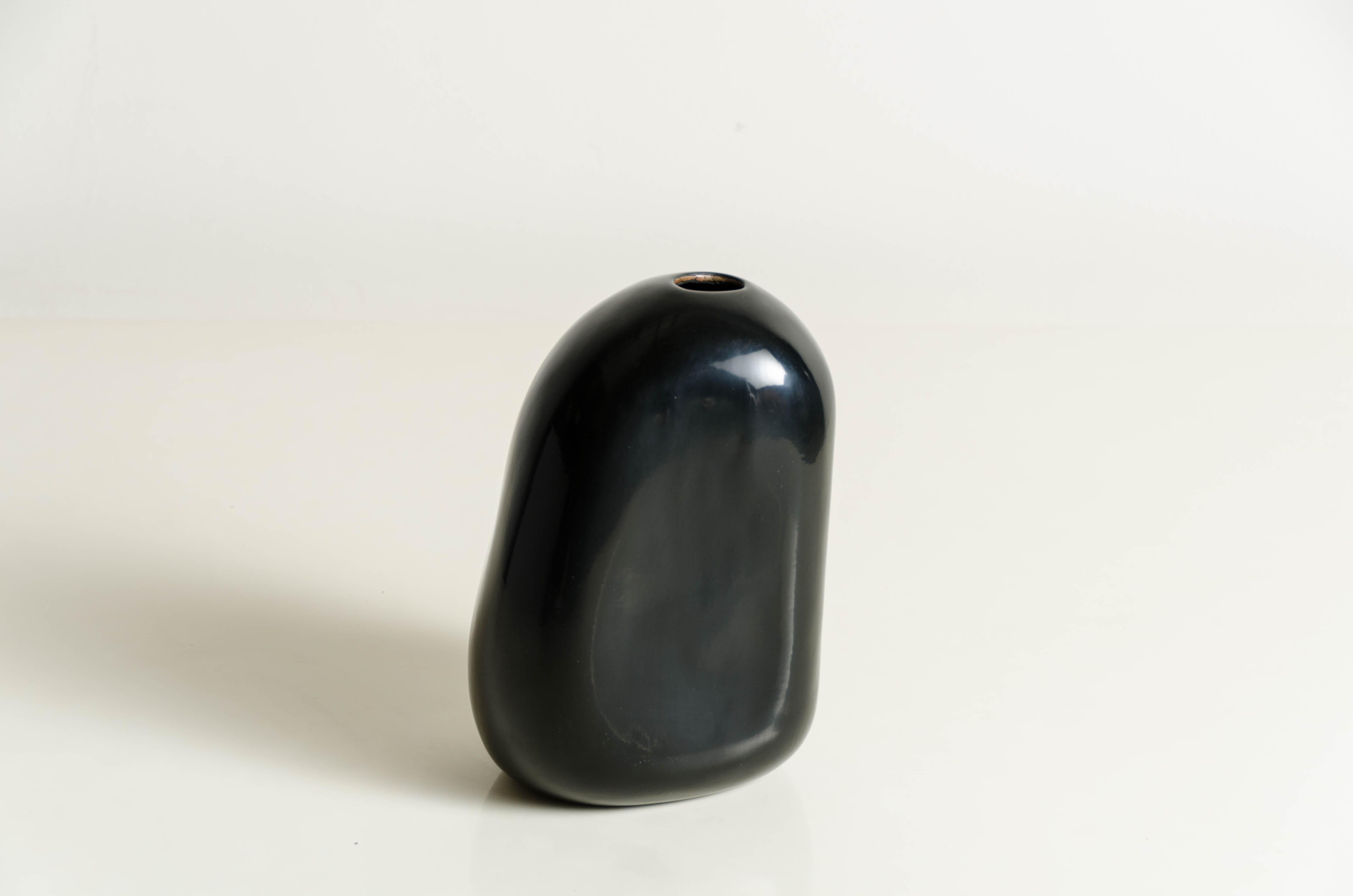 Rock bud vase (Tall)
Black lacquer
Copper base
Handmade / Hand repousse
Limited Edition

Lacquer is a technique that dates back to the Shang dynasty, circa 1600-1100 B.C. These pieces are made with at least 60 coats of organic lacquer. Each