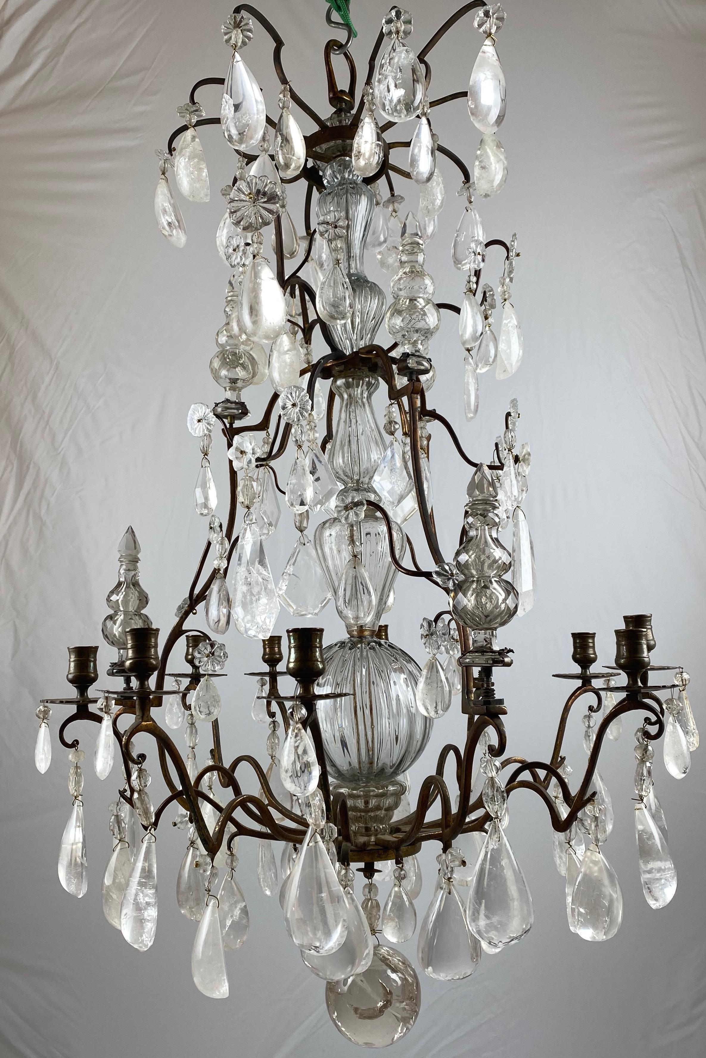 A marvellous chandelier. A mid-18th century chandelier with pendants of rock crystal. The metal frame is bronze and has a fantastic patina.
The central stem is made of hand blown glass.