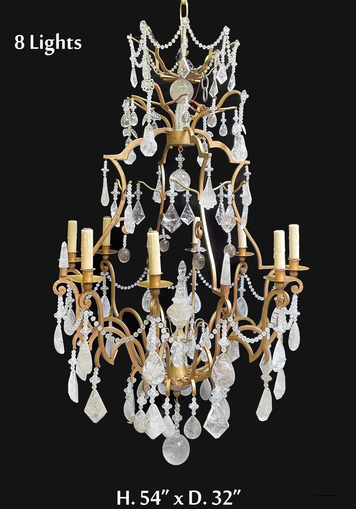 Impressive large French Louis xv style hand carved rock crystal and hand forged wrought iron eight light chandelier, in the antique gold finish. with carved rock crystal spike in the center and beaded swags and lead crystal beads and rosettes.
with