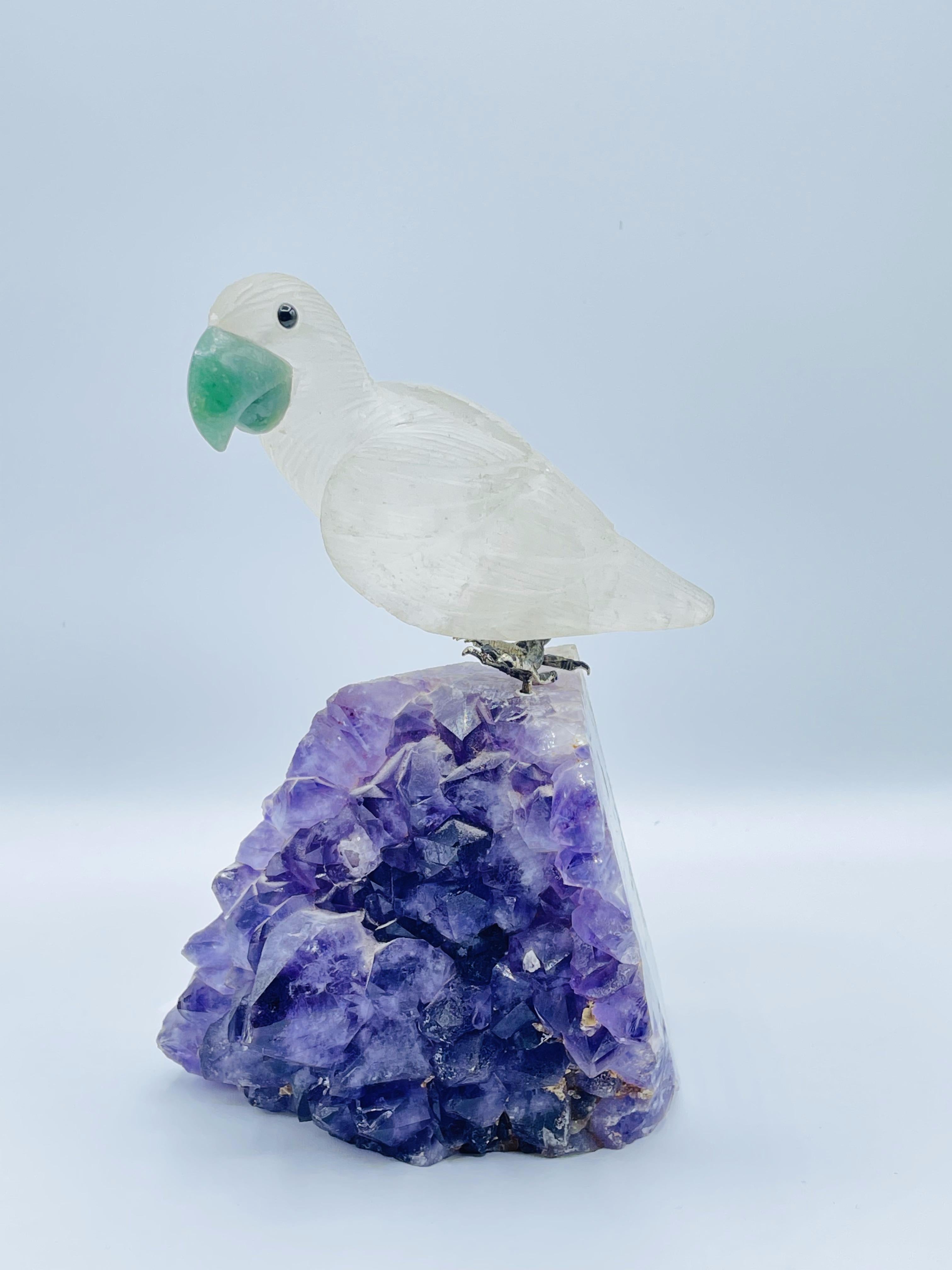 Rock crystal and amethyst Geode sculpture of a carved parrot bird with jade.

Very nice sculpture carving of a rock crystal bird with jade eyes, sitting on a amethyst geode stone.

Good condition. Ready to place.

Measures: 7.5