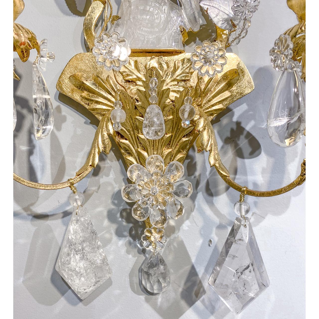 A fine pair of rock crystal sconces with an exquisitely carved rock crystal parrot in the center of both sconces. The parrot is perched on a log with a gorgeous assortment of crystal leaves and flowers surround the it. Two flowers with individual