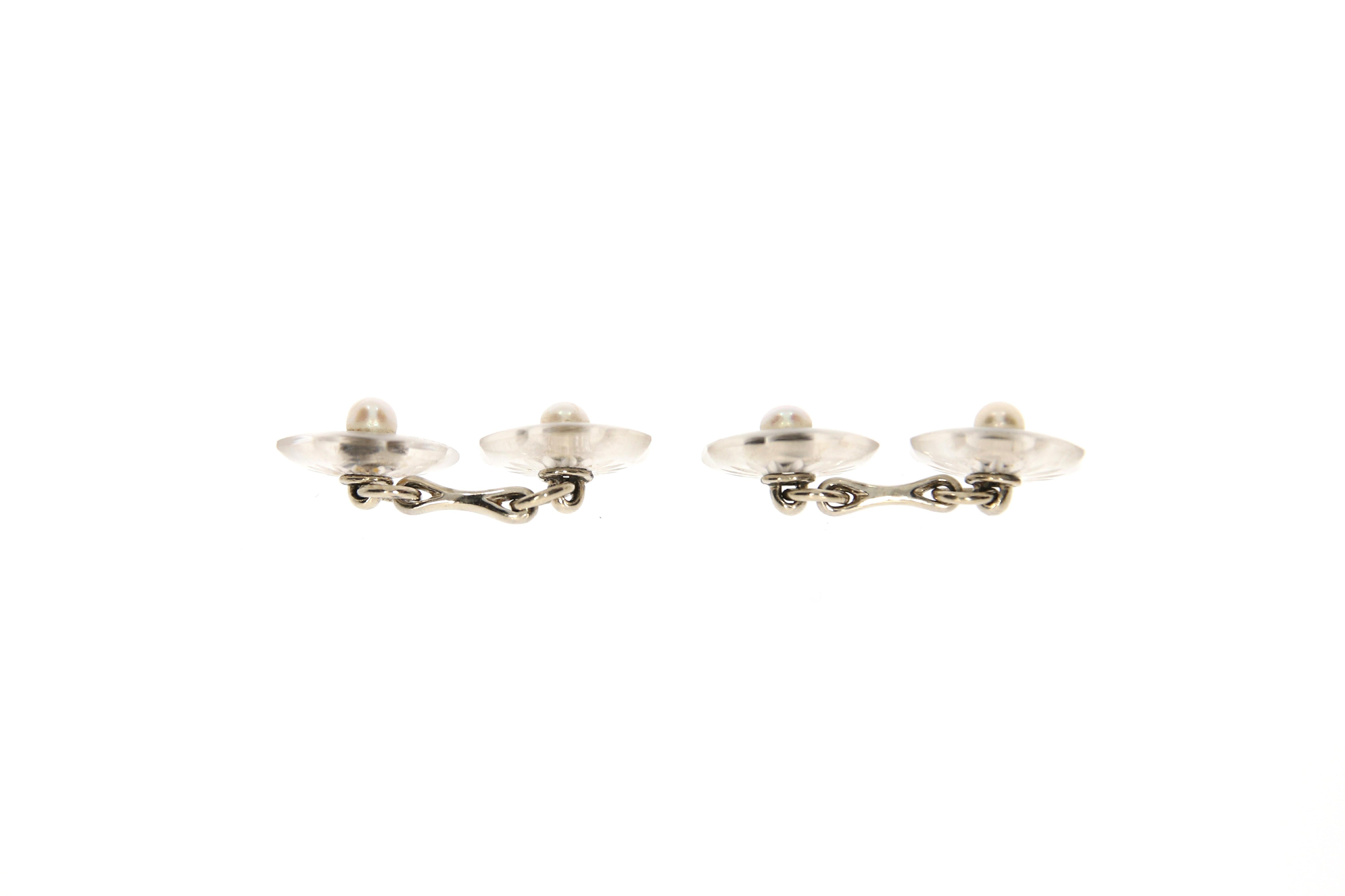 A delightful pair of rock crystal Cufflinks. Each designed as a flower, centered by 4 natural pearl buttons. Floral engravings. Platinum setting.