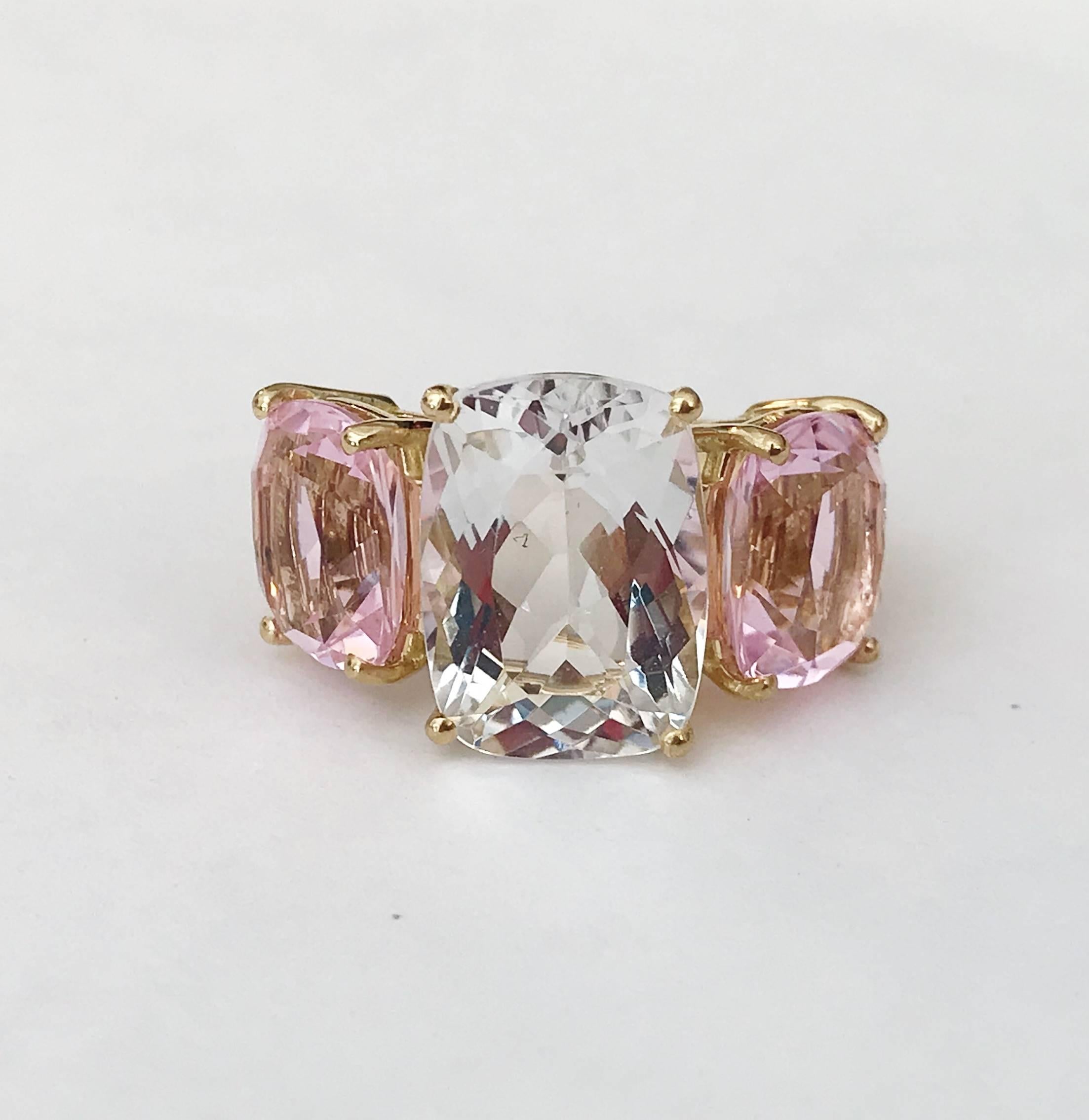 18kt Rose Gold Three Stone faceted Cushion Ring with center Rock Crystal and two Pale Pink Topaz finished with a tapered split shank.

This elegant cocktail ring measures 1 1/4