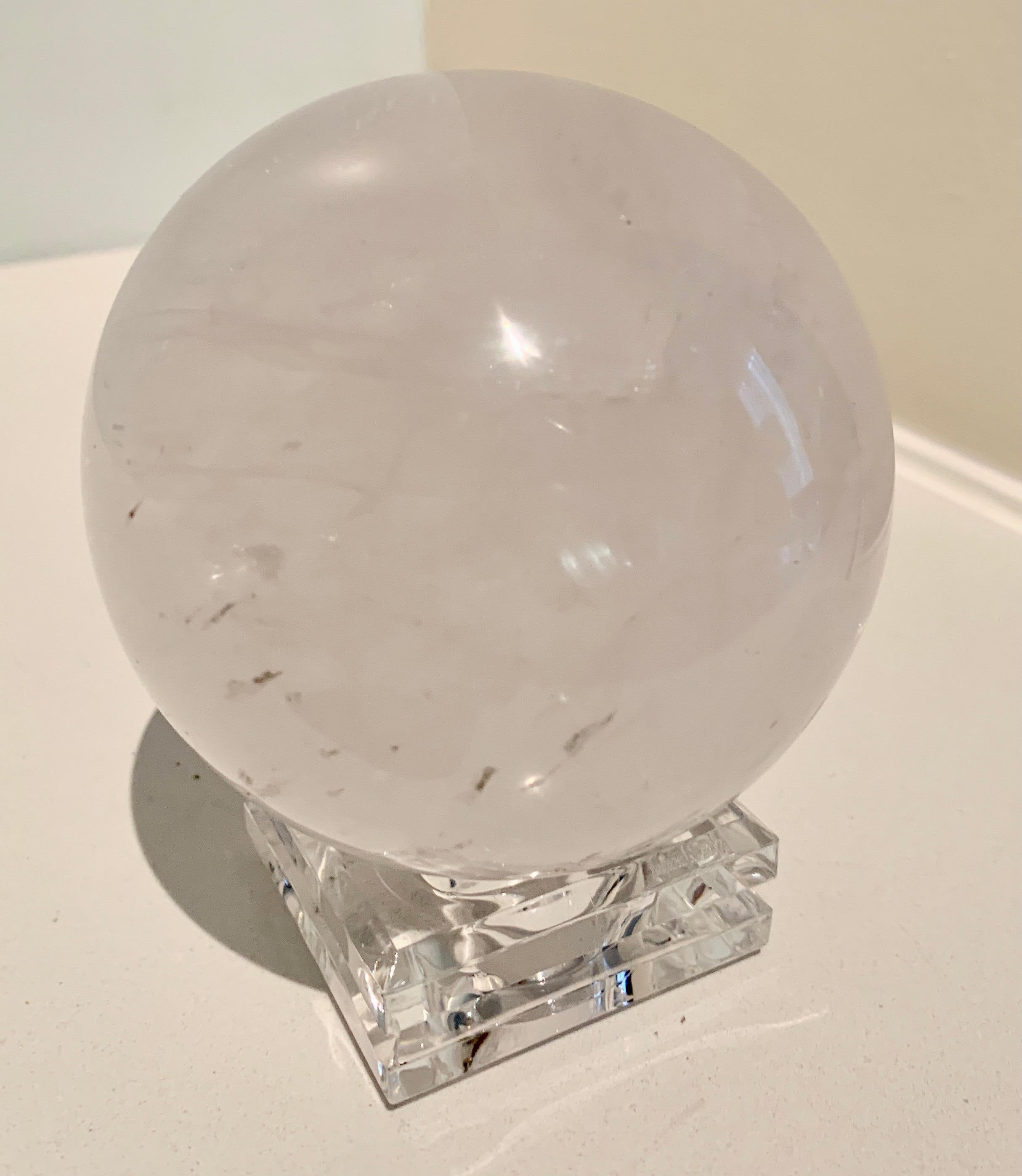 Rock crystal ball on stand - a lovely rock crystal specimen on an acrylic base, which also looks to be cut crystal. A compliment to any desk or shelf. Use as a paper weight or sculpture.