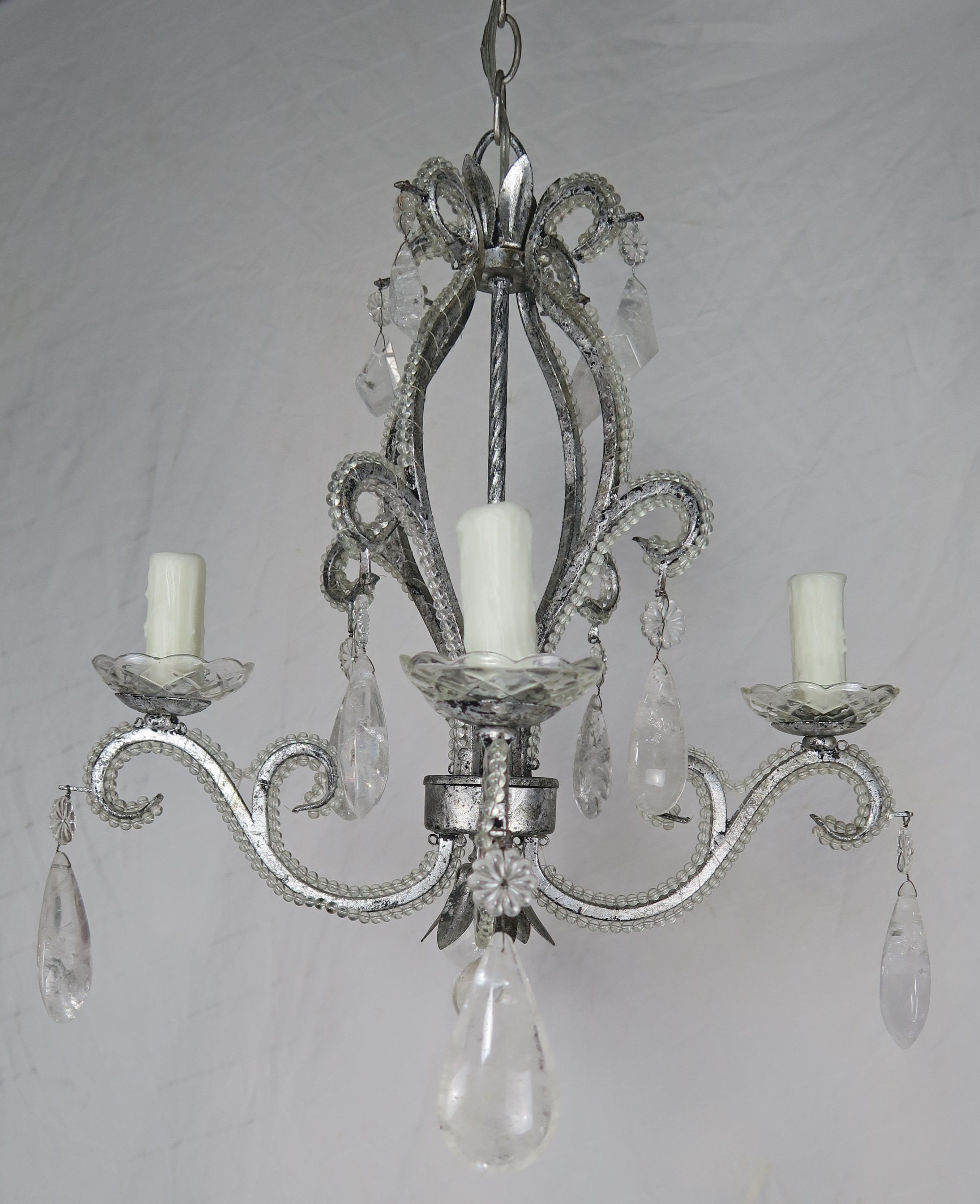 Rock crystal beaded silver gilt metal 4-light chandelier adorned with kite and almond shaped rock crystals throughout. The fixture is newly rewired with drip wax candle covers and includes chain and canopy.