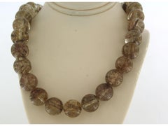 Rock crystal beads with rutile inclusions and 18k gold claps with diamonds