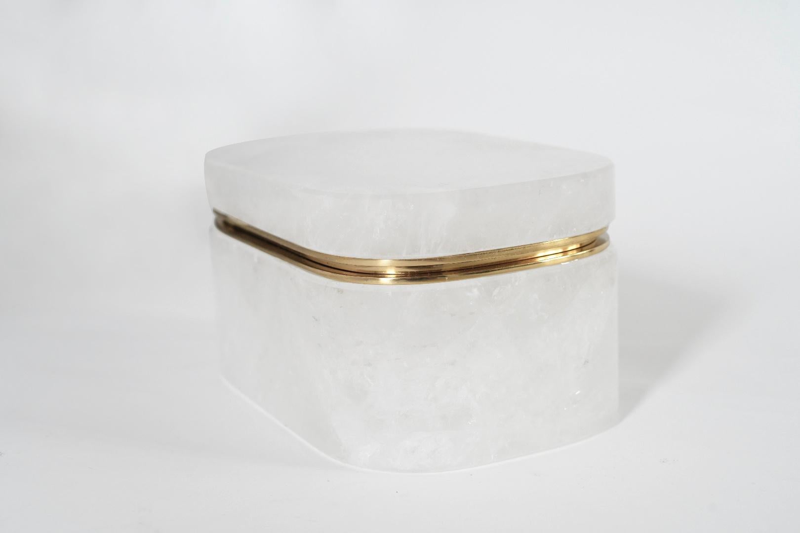 Finely carved oval form rock crystal box with cover. Brass decoration. Created by Phoenix Gallery, NYC.
