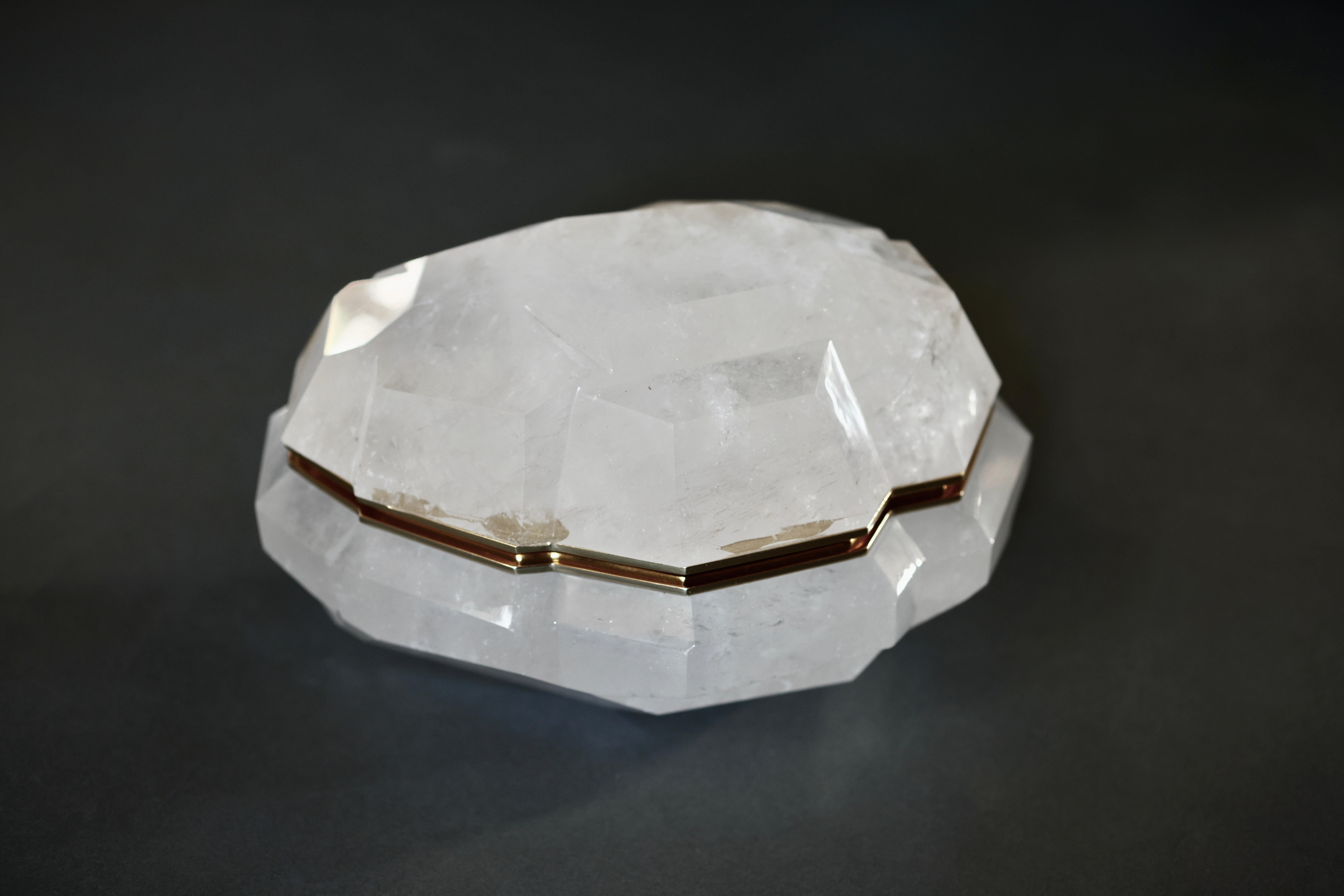Finely carved multifaceted rock crystal box with cover. Polish brass decoration.created by Phoenix Gallery.