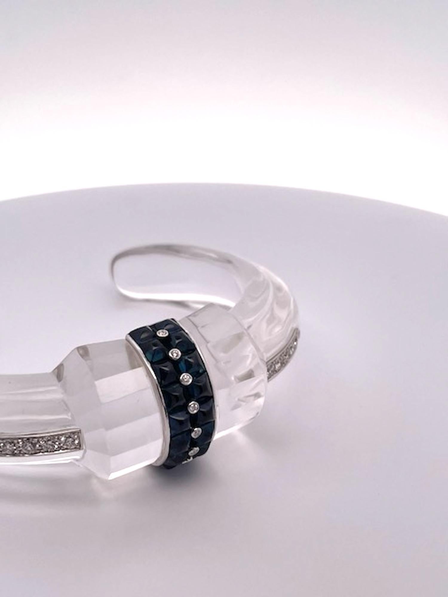 This rock crystal bracelet is clean and lovely.  It sports eight (8) buff top Sapphires with seven (7) collet Diamonds in the center.  It also boosts 6 Diamonds on each side for a bit more spark.  The inside is stamped Boucheron but with further