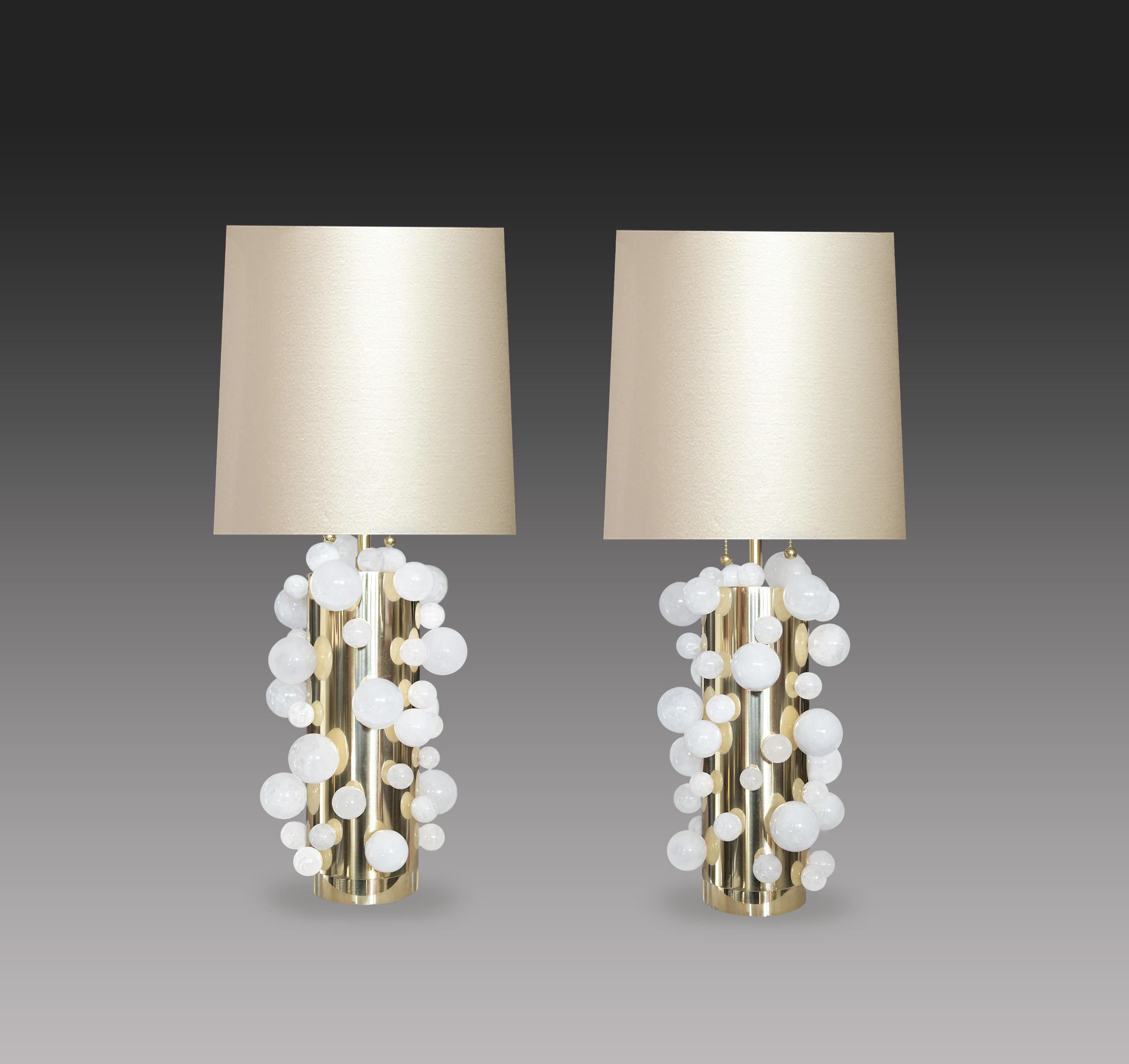 A pair of luxury white rock crystal quartz bulb lamps with polished brass bases, created by Phoenix Gallery, NYC.

(Lampshade not included).