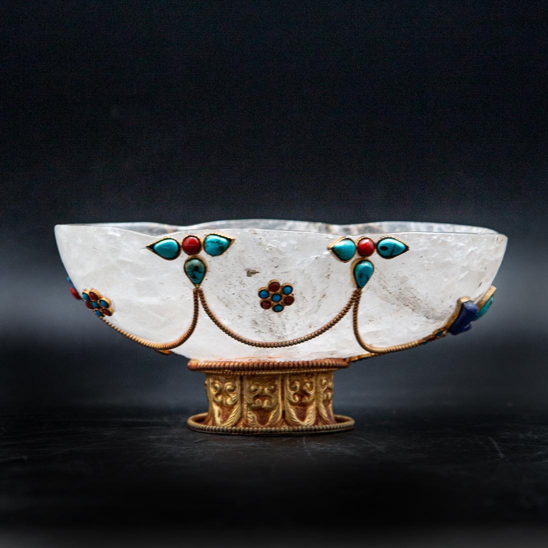 Rock crystal carved footed bowl with turquoise and coral. Rock crystal carved bowl with applied stones of coral, turquoise, and lapis lazuli set in gilt metal. Handcrafted in Nepal. Measures: 6