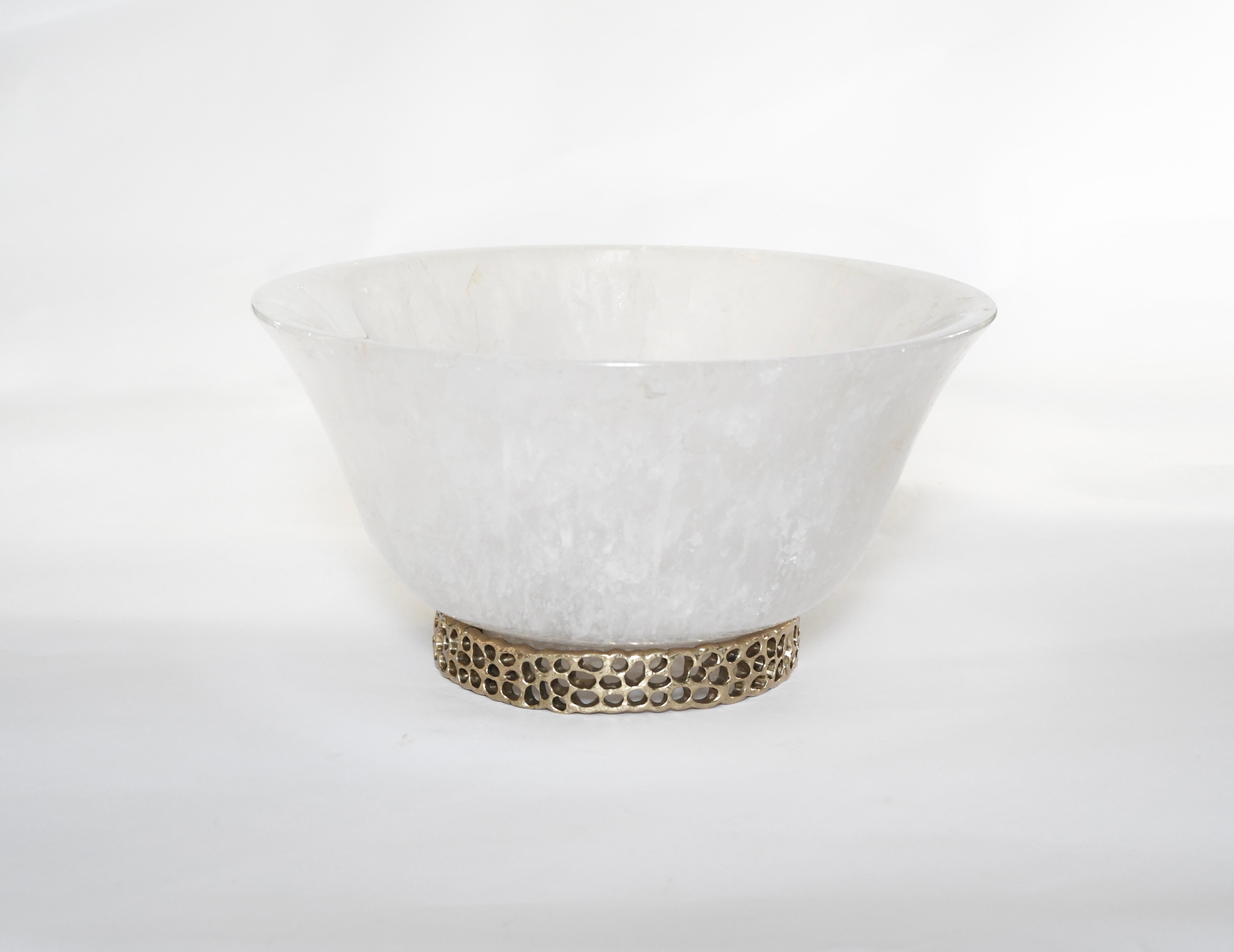 Carved rock crystal centerpiece. Designed brass base with hammered detail. Created by Phoenix Gallery, NYC.
 