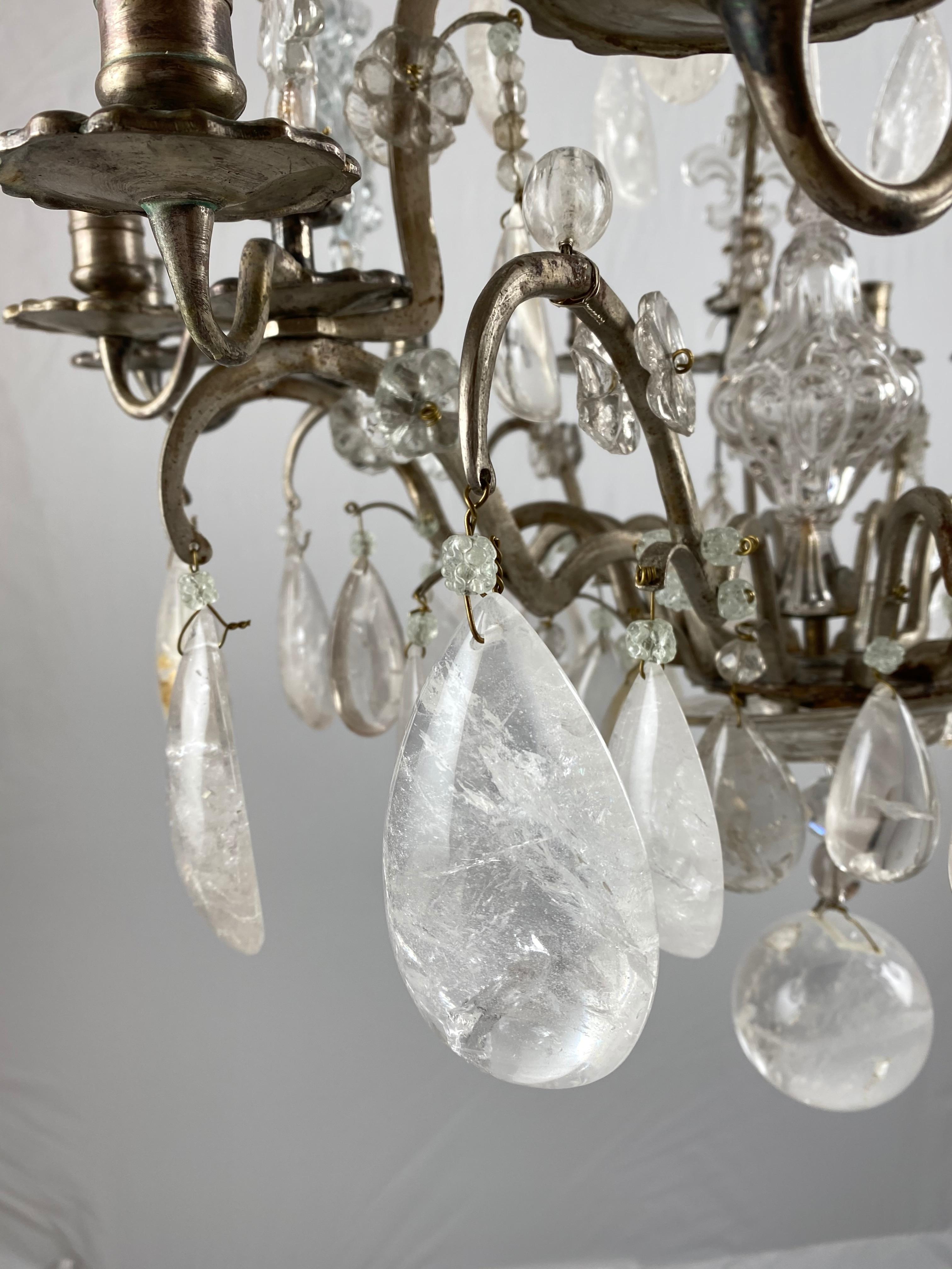 A fine mid-18th century chandelier. The metal frame is made of silvered brass with a fine patina. The chandelier has rock crystal pendants, round, pear and eggshaped.