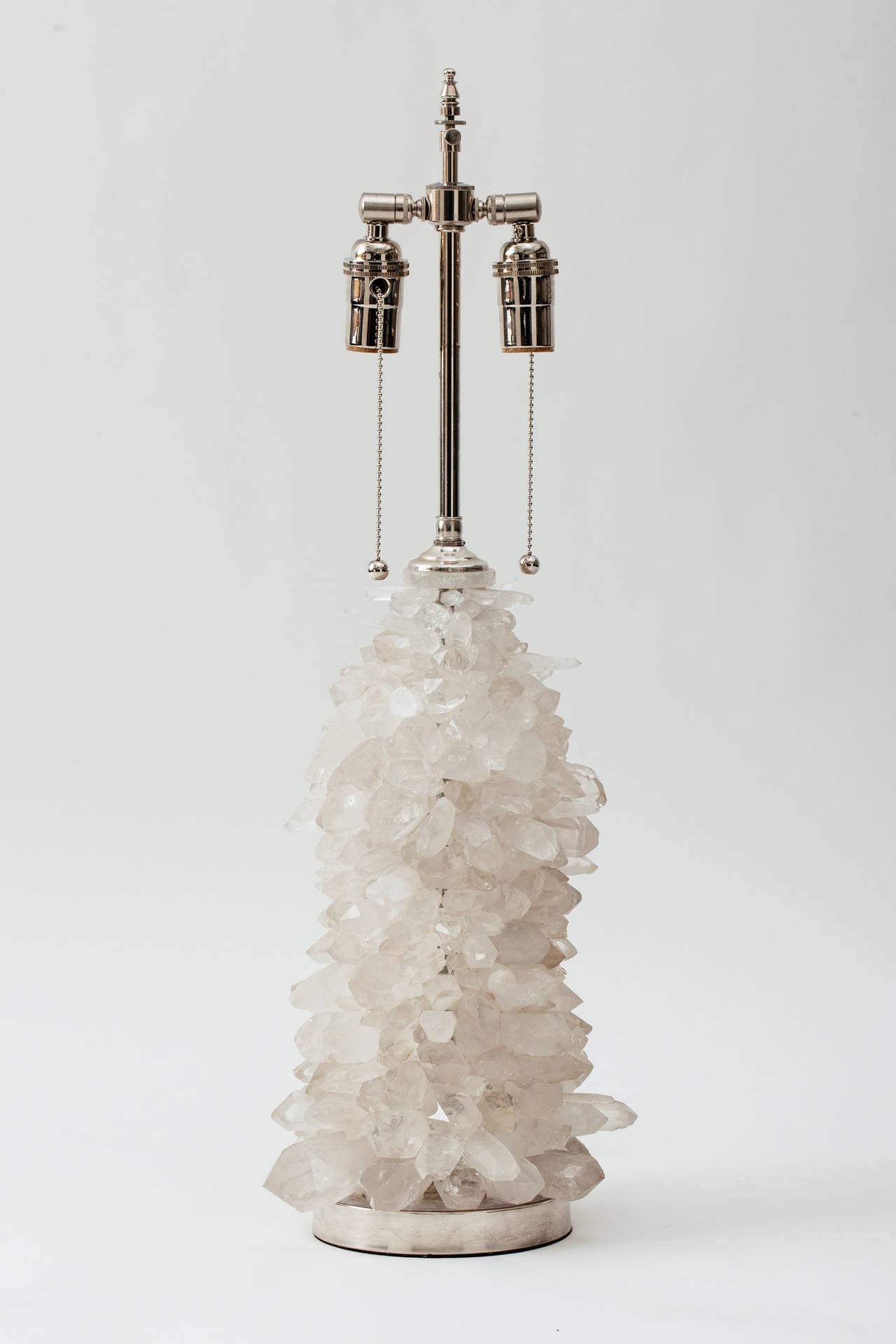 Handcrafted rock crystal cluster lamp with nickel-plated solid brass base and hardware. Double socketed with pull chain switches. 
100 max wattage per socket. Lamp body measures 15 inches height, 
Lamp shade not included.
