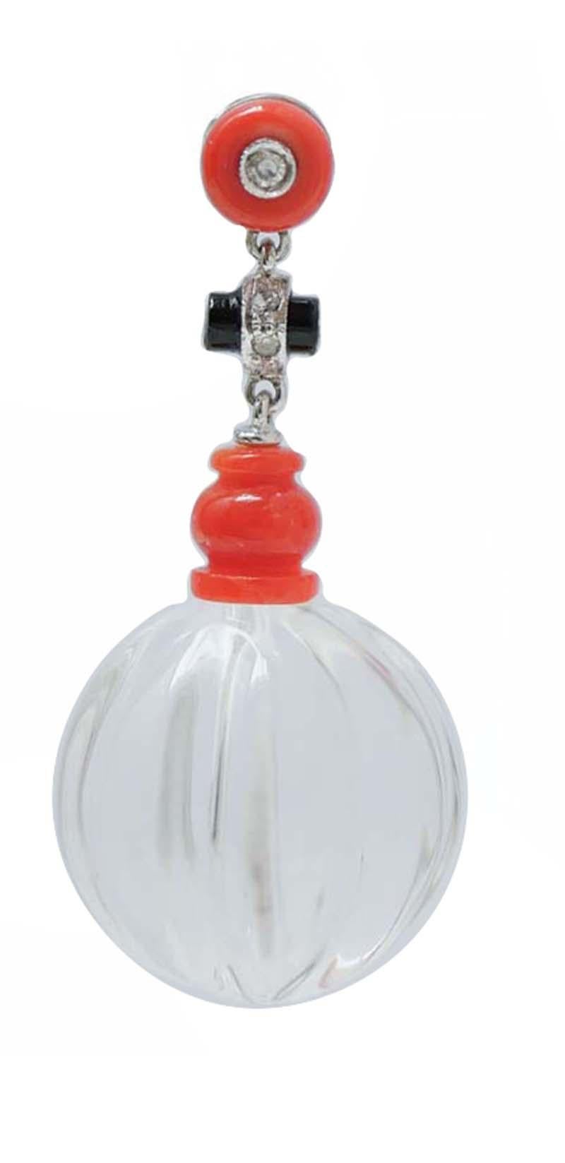 Beautiful dangle earrings in platinum structure mounted with a coral and a diamond in the upper part;in the middle, an onyx with diamonds and a coral and, as pendant, a rock crystal.
These earrings were totally handmade by Italian master goldsmiths