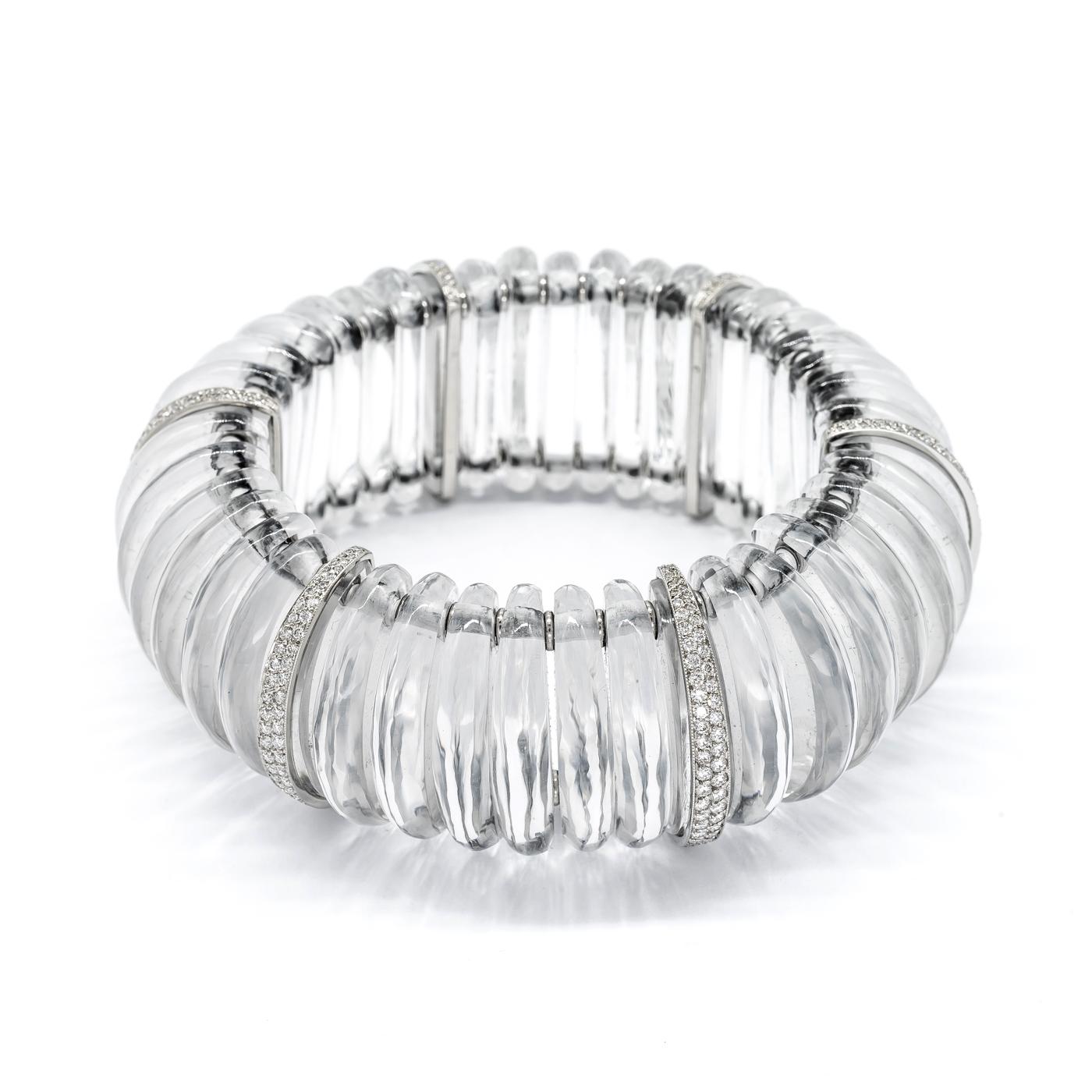 A rock crystal and diamond bracelet, on springs, with spacers, set with two rows of diamonds in platinum settings. 