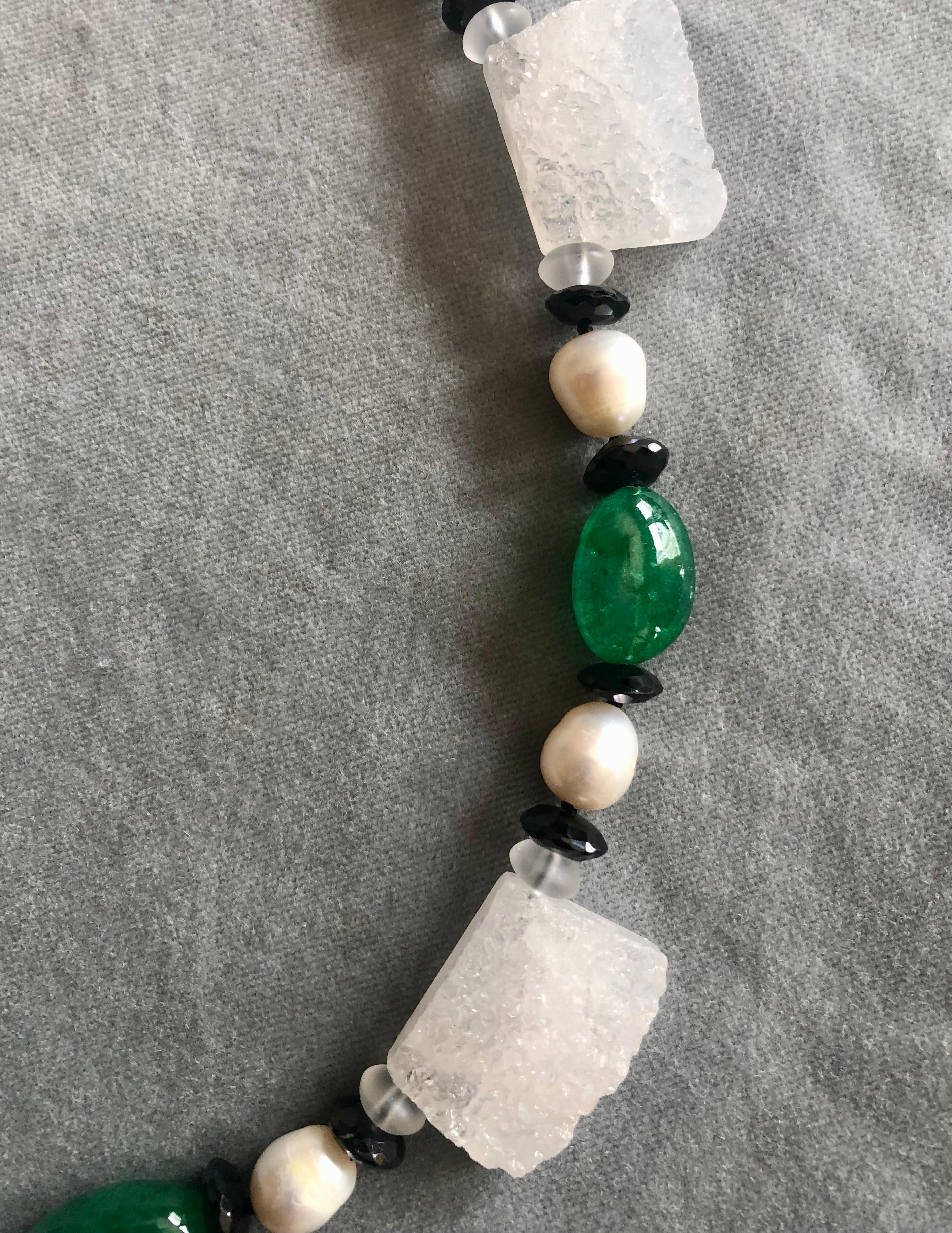 Striking and unique single strand necklace of segmented rock crystal druzy flanked with satin finished rock crystal rondelles. Alternating stations of white freshwater cultured pearls, onyx rondelles and large tumbled emerald nugget beads. The