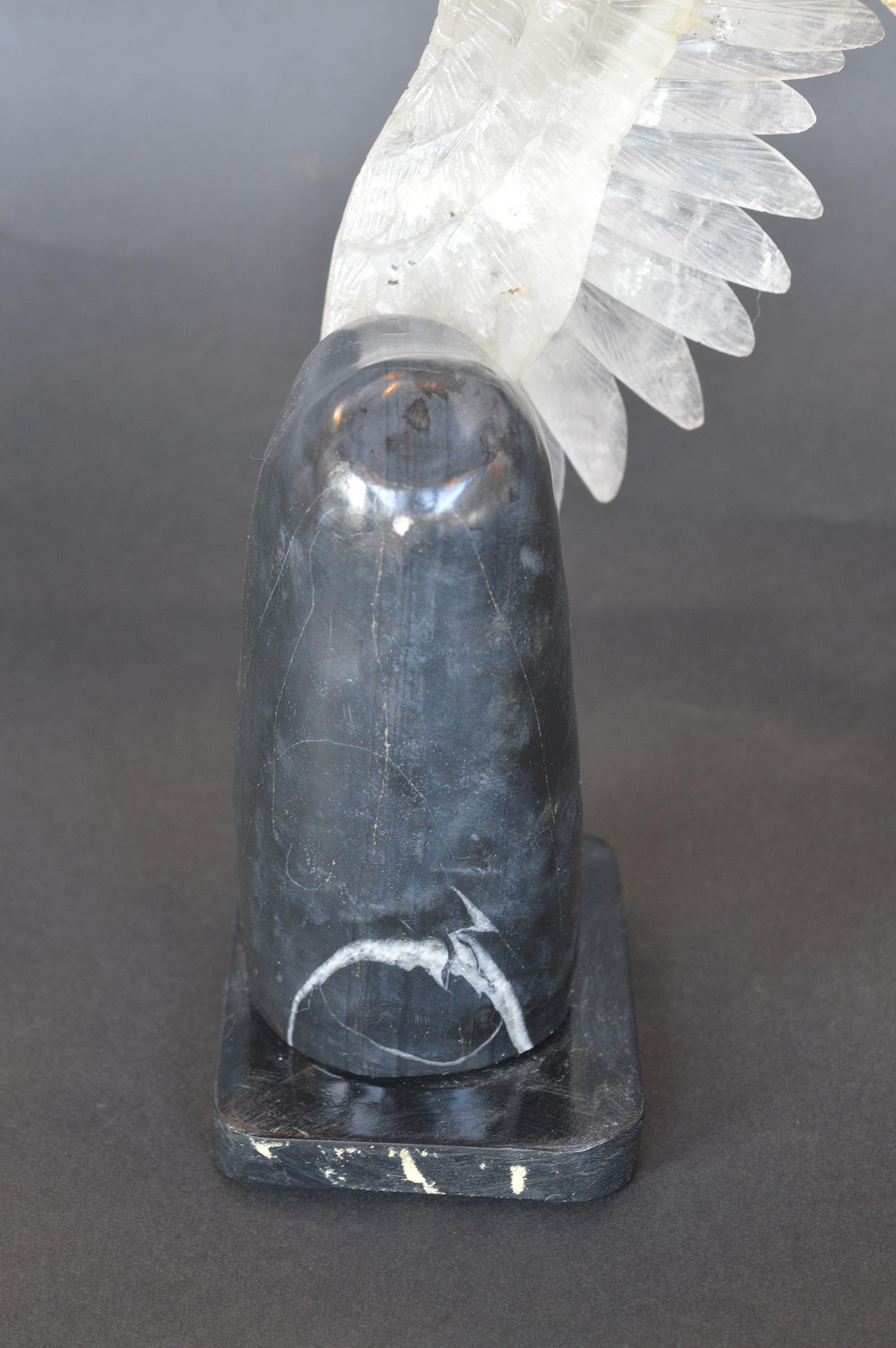 Rock crystal eagle mounted on a black marble base. Beak and talons are gilded bronze.