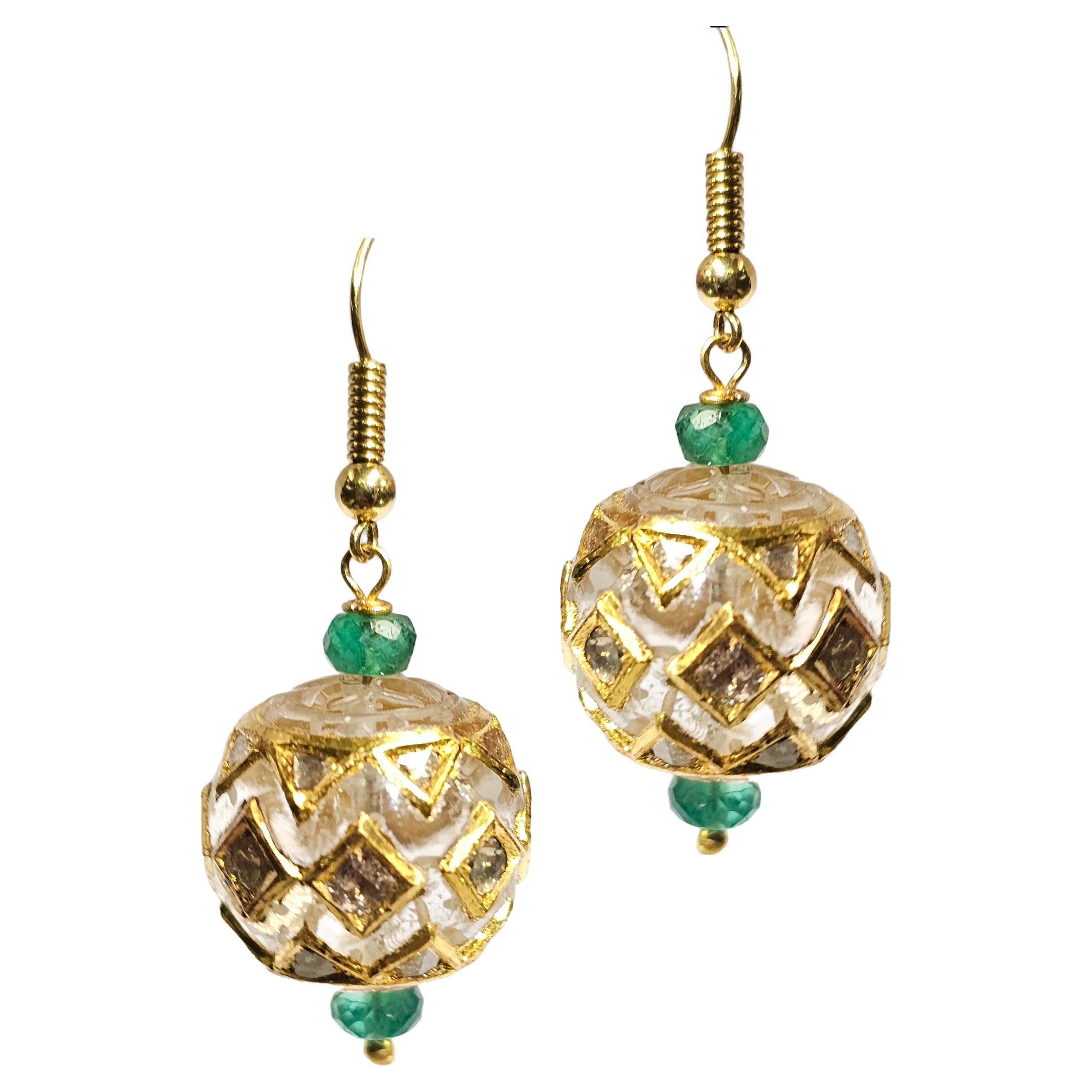  Rock Crystal & Emerald Bead Earrings

A pair of earrings made of 14 karat yellow gold, carved rock crystal beads, and carved emerald beads

Length: 1.5