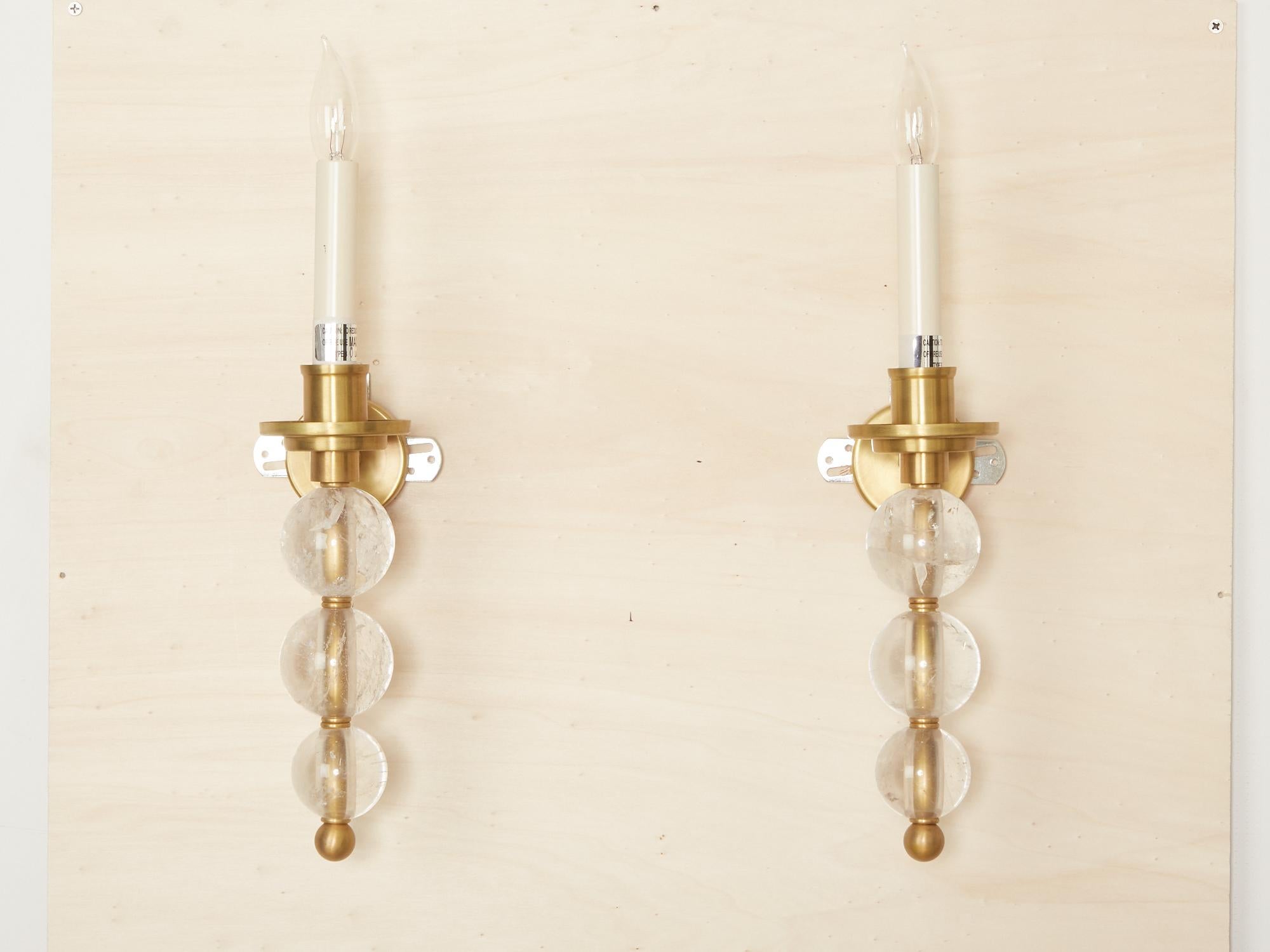 A pair of custom single-light Ephorus sconces with a satin brass finish and three rock crystal balls.
