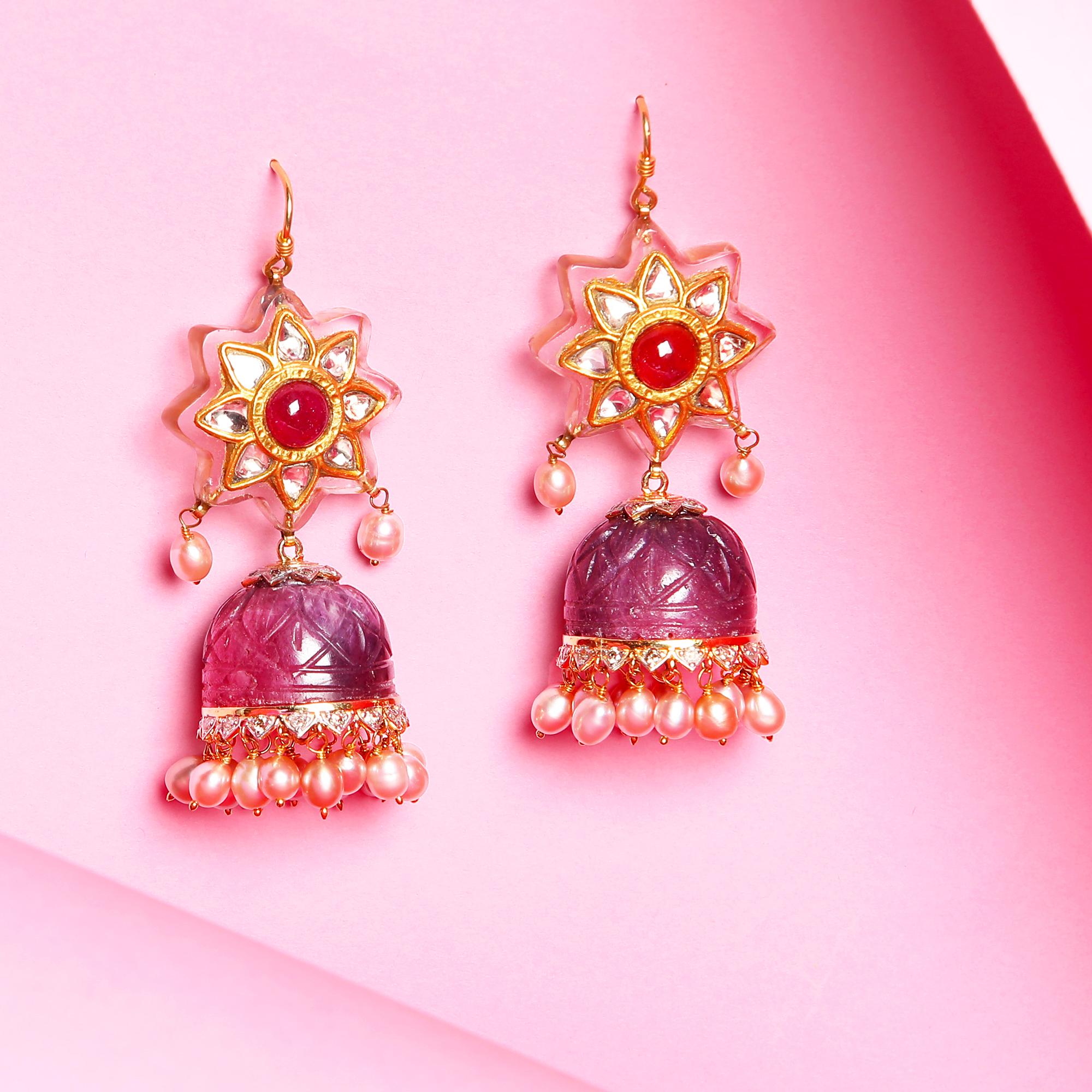 Intricately carved rock crystal Jhumkas (Umbrella shaped danglers) flanked by Rubies, Diamonds and Pearls. Set in gold.