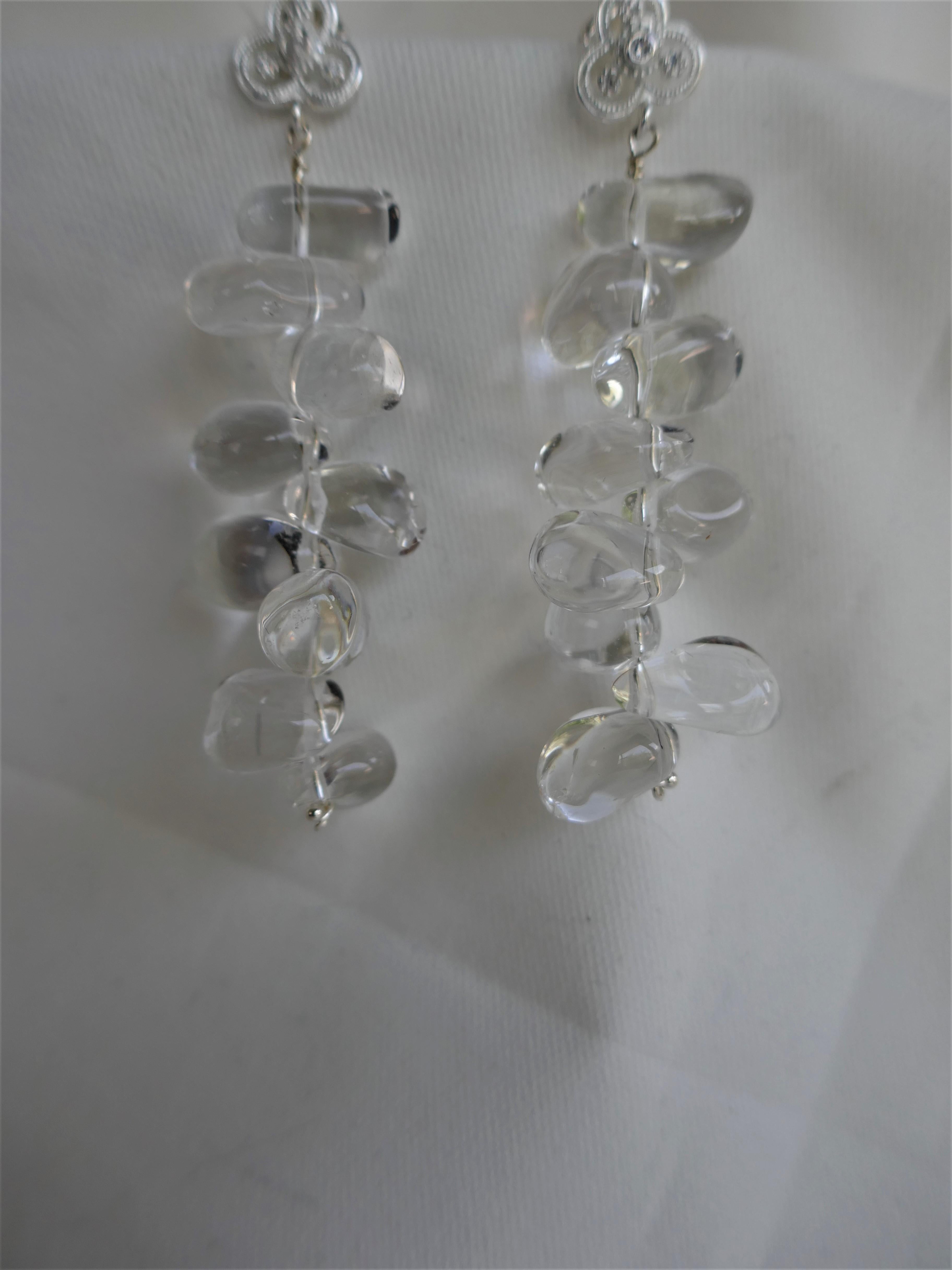 These earrings are so wearable and look beautiful on. Limited edition. The rock crystal nuggets are great quality and hang from 925 sterling silver and cubic zirconia post. The post are push backs. The earrings are 2 5/8th inches long. Designed and