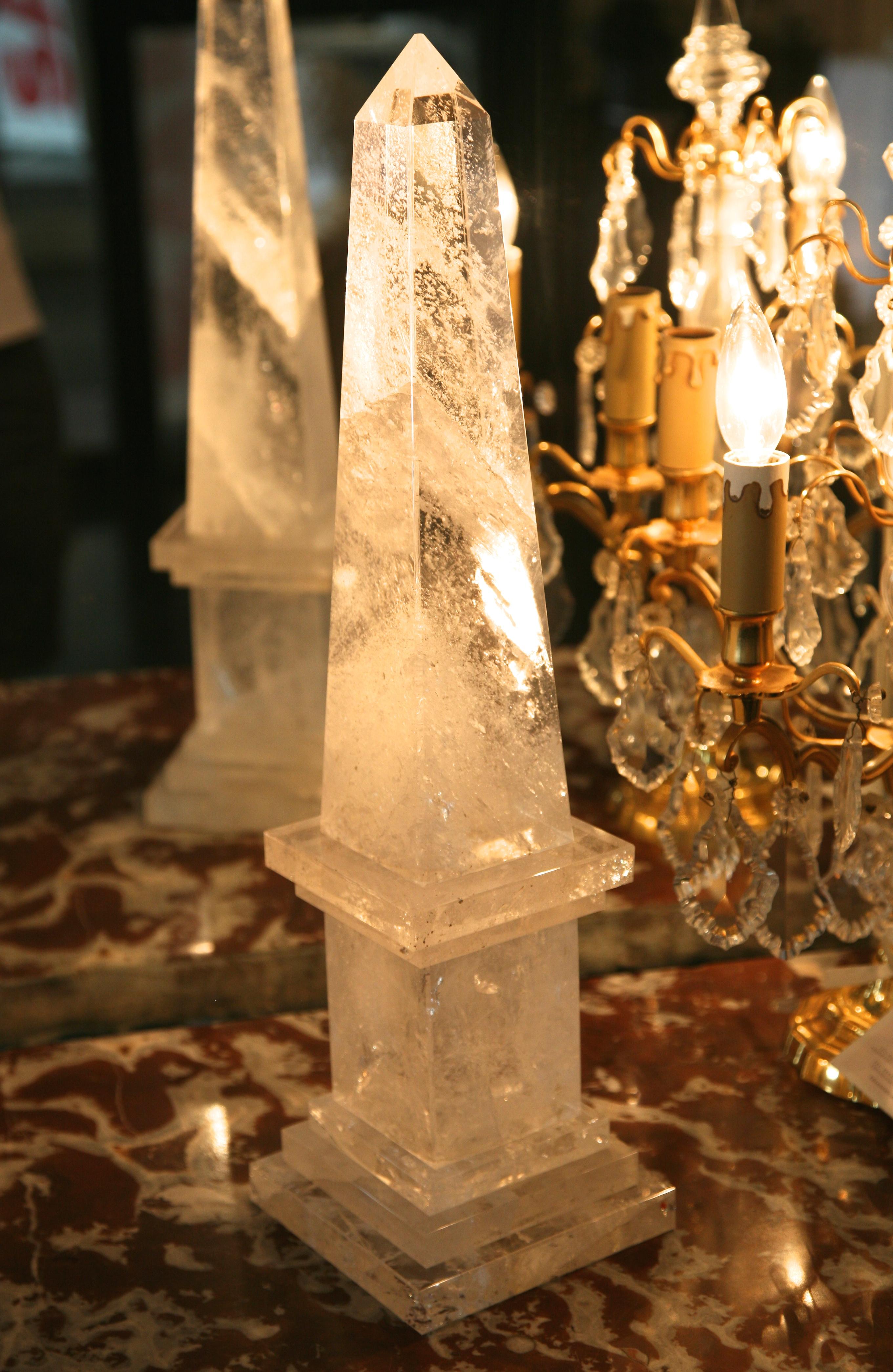 Fine large pair of neoclassical rock crystal obelisks with square base. Very harmonious proportions, exquisite clarity, French, early 20th century.
An architectural pair of decorative, Mid-Century Modern, Neoclassical Rock Crystal obelisks upon