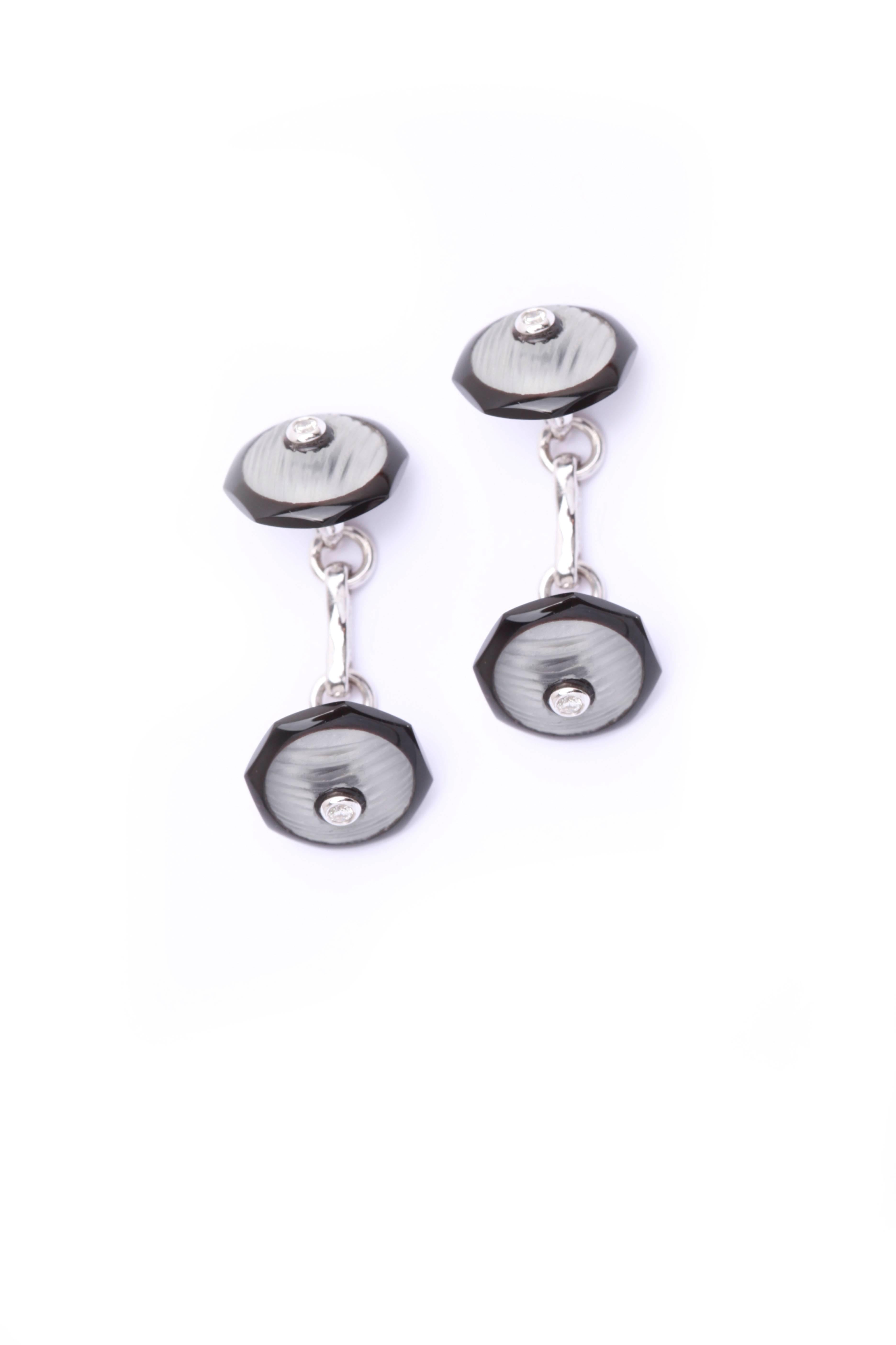 An elegant pair of rock crystal, onyx and diamond cufflinks, mounted on 18kt white gold. Circa 1980 
