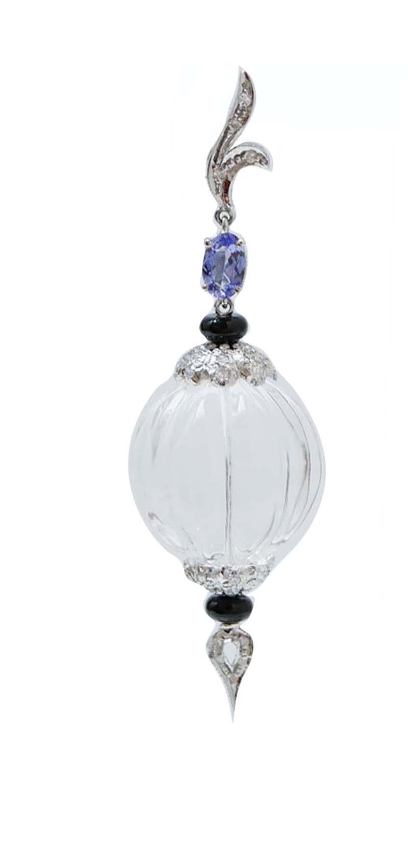 Amazing dangle earrings in 14 kt white gold structure mounted with diamonds and tanzanite  in the upper part. In the middle, a sphere of rock crystal ( 18 mm) between two structures studded with diamonds and, below, an onyx and a drop pf