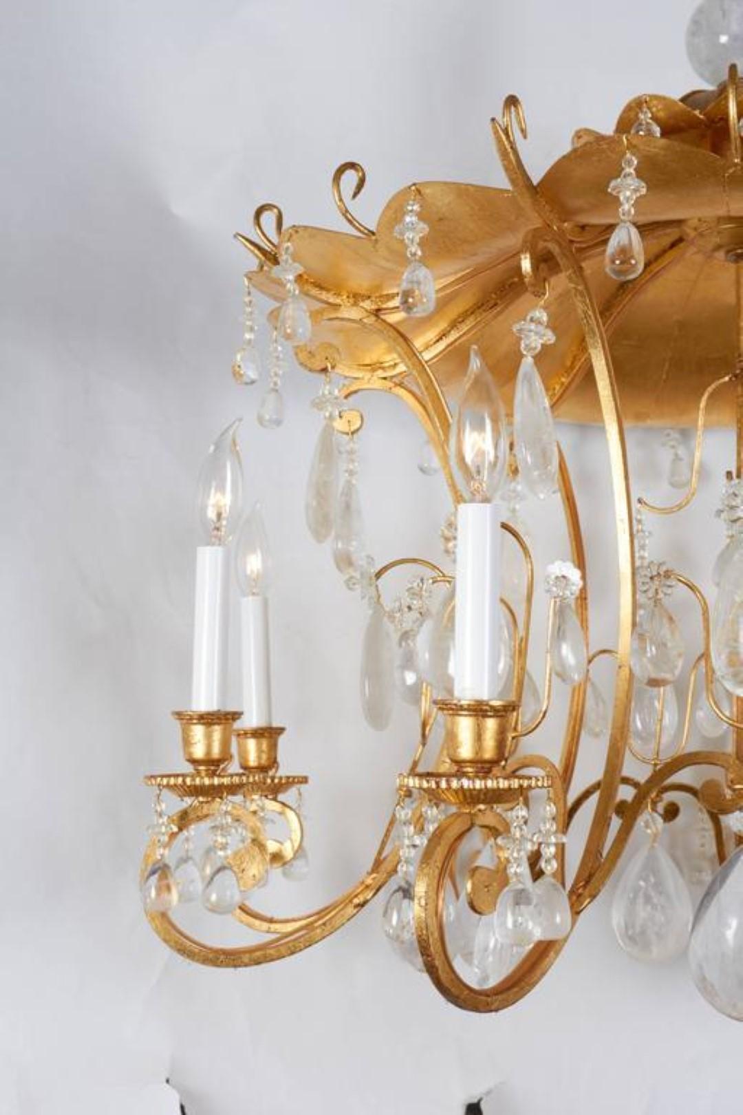 A new chinoiserie style rock crystal and gilt metal eight-light chandelier, the pagoda with eight out-scrolled candle-branches suspending faceted rock crystal drops, in the manner of Maison Bagues by David Duncan Studio.