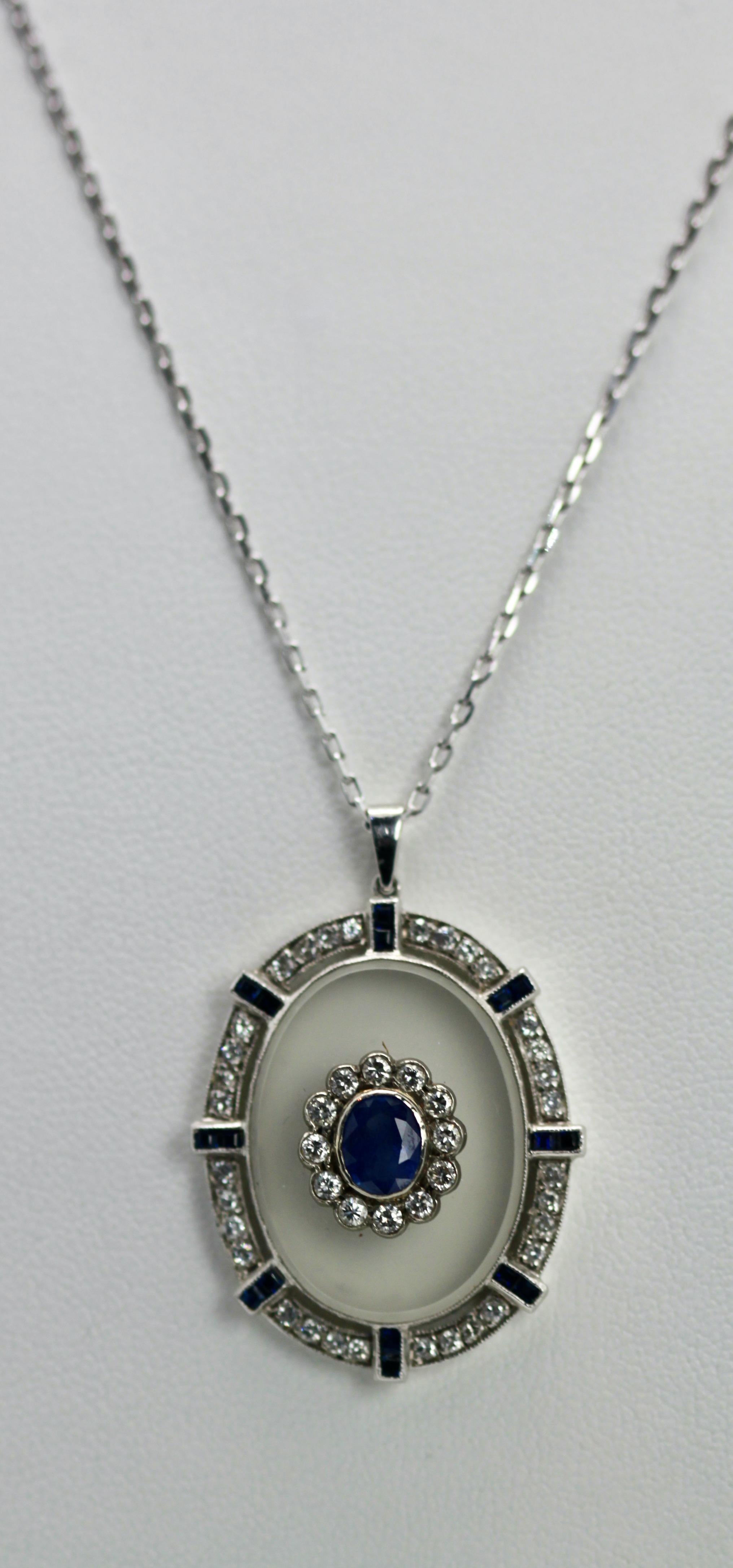 I just love this pendant. This pendant is beautiful with a frosted Rock Crystal base set with a Sapphire with Diamond surround.  The crystal is set with Diamonds and Sapphires on a simple chain.  The center stone is 0.75 carats, each baguette stone