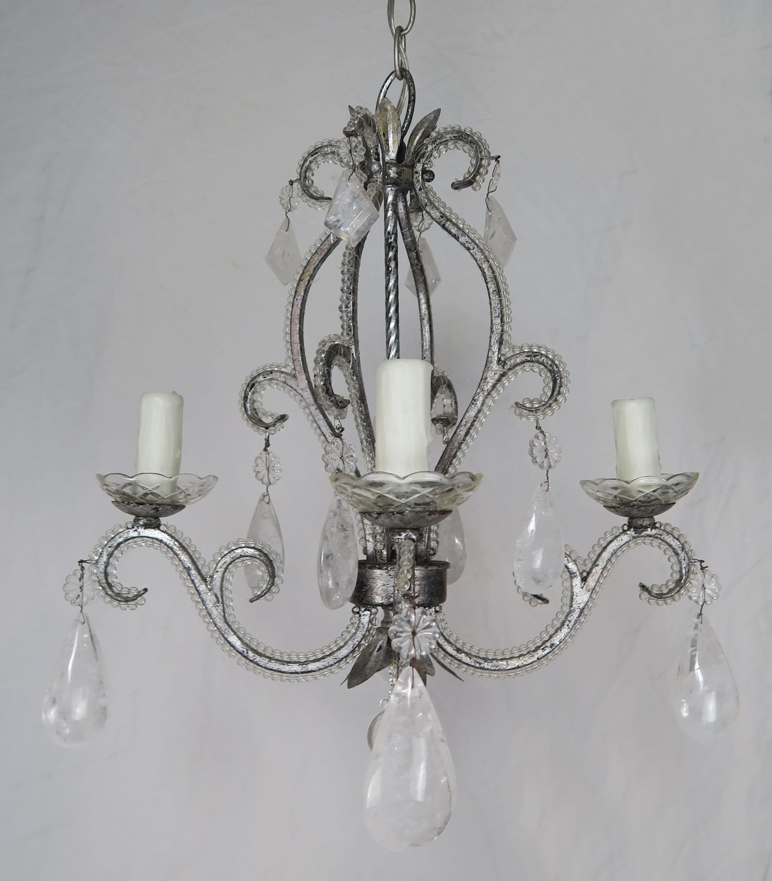 Rock crystal beaded pewter finished metal 4-light chandelier adorned with kite and almond shaped rock crystals throughout. The fixture is newly rewired with drip wax candle covers and includes chain and canopy.
 