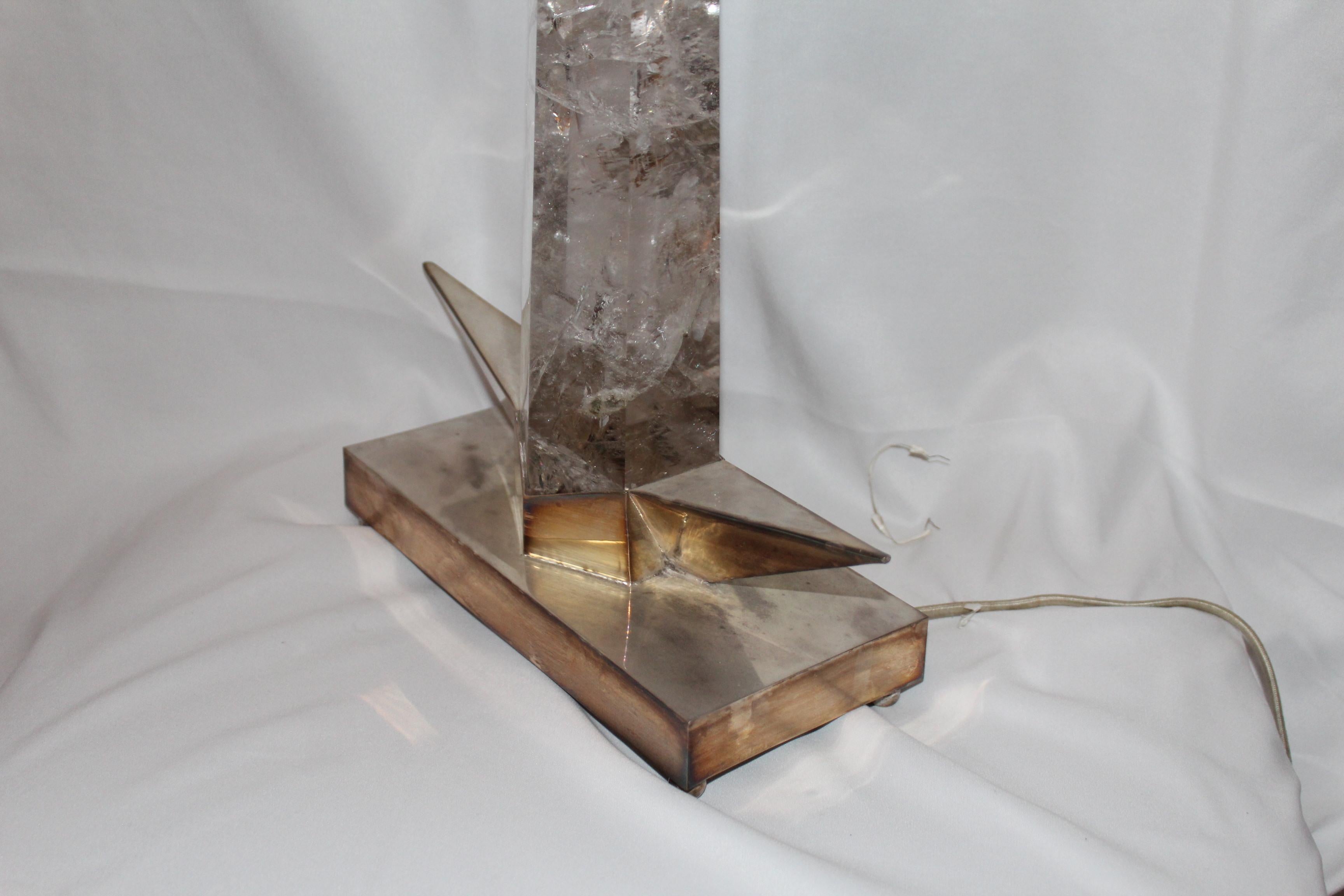 A great find of a large almost clear quartz crystal that was custom mounted on special designed base after the original by (Gustave Miklos). The only other one is on display at the Virginia Museum of fine art now. Base is solid brass and silver