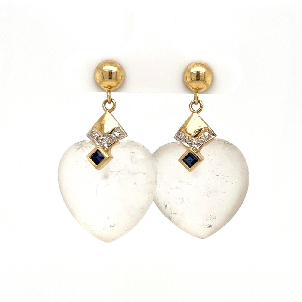 Simply Beautiful! Finely detailed Rock Crystal Quartz Hearts Dangle Earrings, accented with Sapphire gemstones and Diamonds, weighing approx. 0.05tcw. Hand crafted with 14K Gold mounting. These Simple and Classic yet elegant earrings, epitomizes