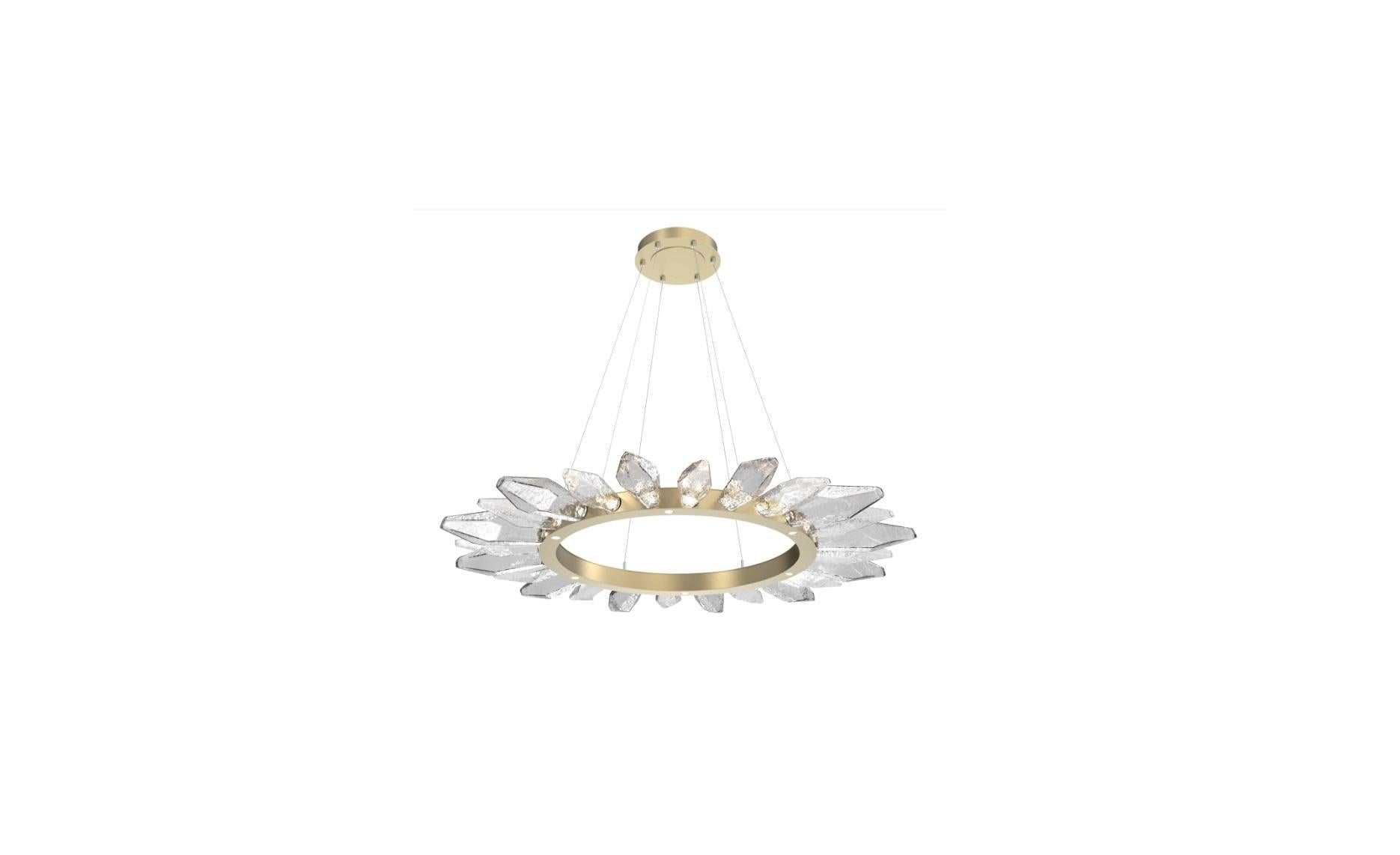 Like a bright sunflower, the Rock Crystal radial ring chandelier shines from the inside out. Juxtaposing LED-illuminated artisan blown glass shades reminiscent of quartz crystals with hand-polished steel, the Radial Ring exudes dramatic modern