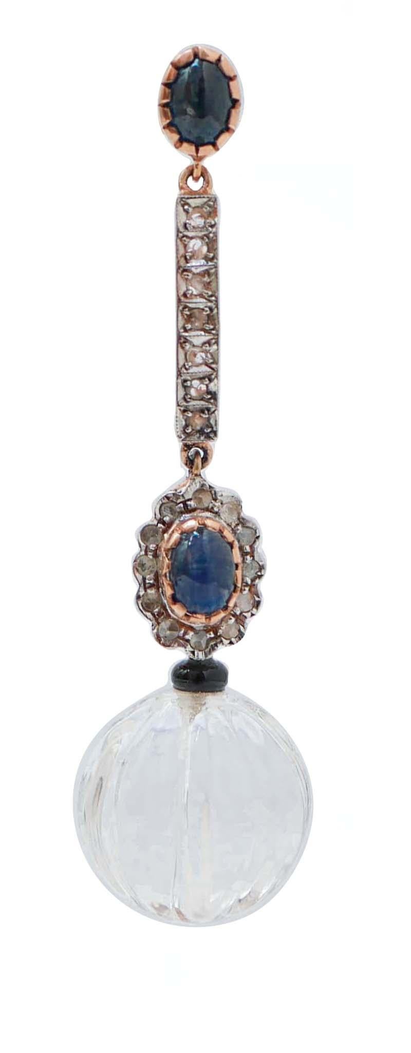 Fantastic dangle earrings in 9 kt rose gold and silver structure mounted with a sapphire in the upper part. In the middle, diamonds and a flower of diamonds with a central sapphire. Below, an onyx and a sphere of rock crystal.
These earrings were