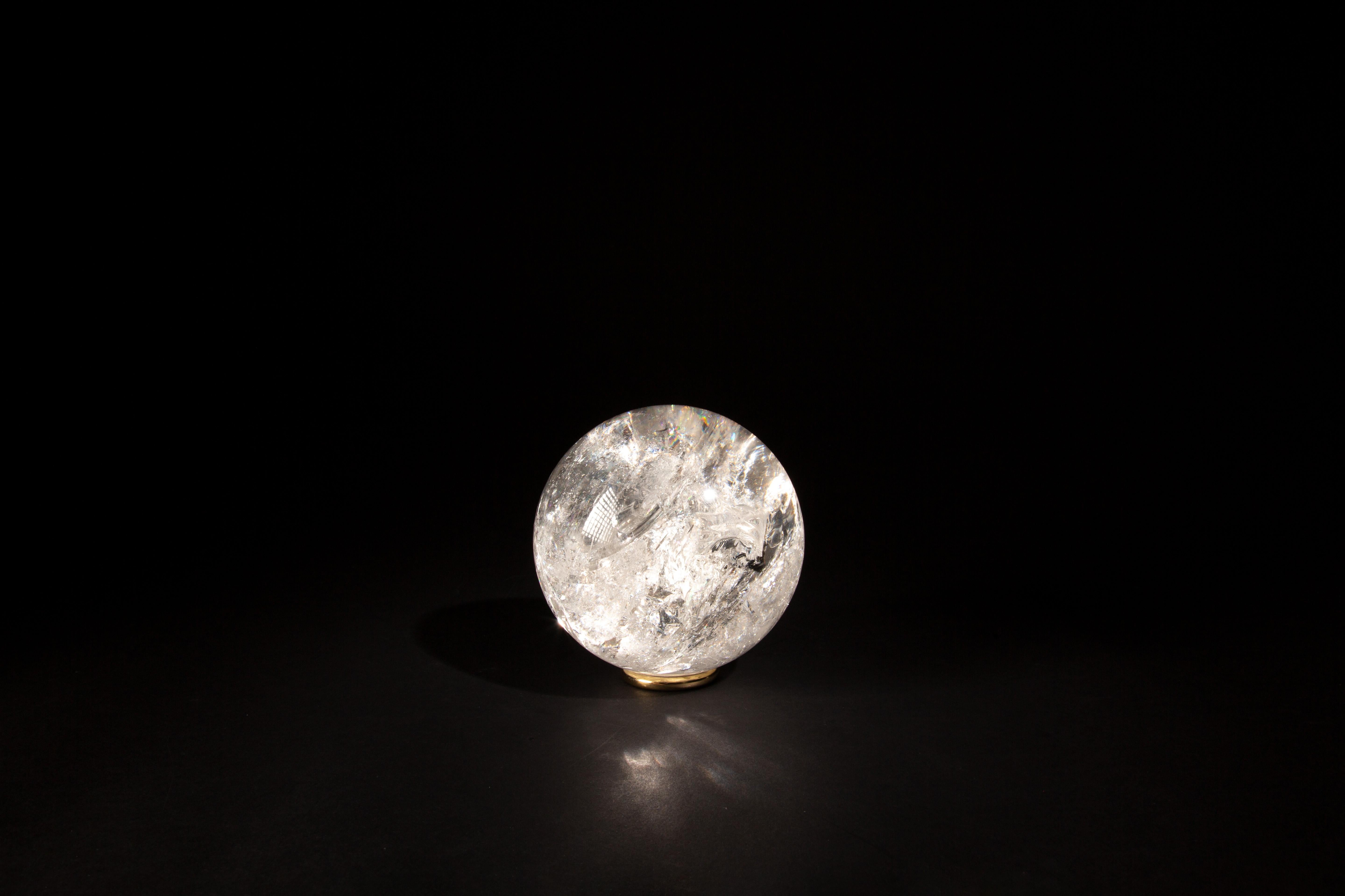 This 4.5-inch Rock Crystal Sphere exemplifies the purity and elegance of natural quartz. Expertly crafted and polished to a flawless finish, this sphere highlights the inherent clarity and brilliance of rock crystal. Its transparent surface captures