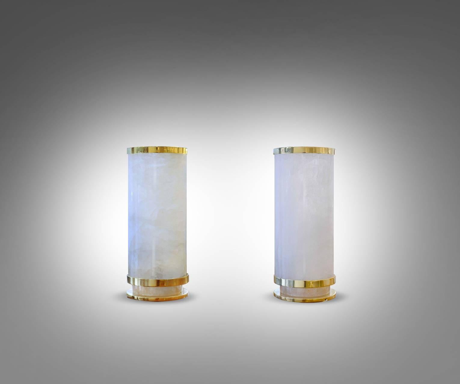 Cylinder form rock crystal table lights with polish brass decoration.100w max each. Created by Phoenix gallery NYC.
