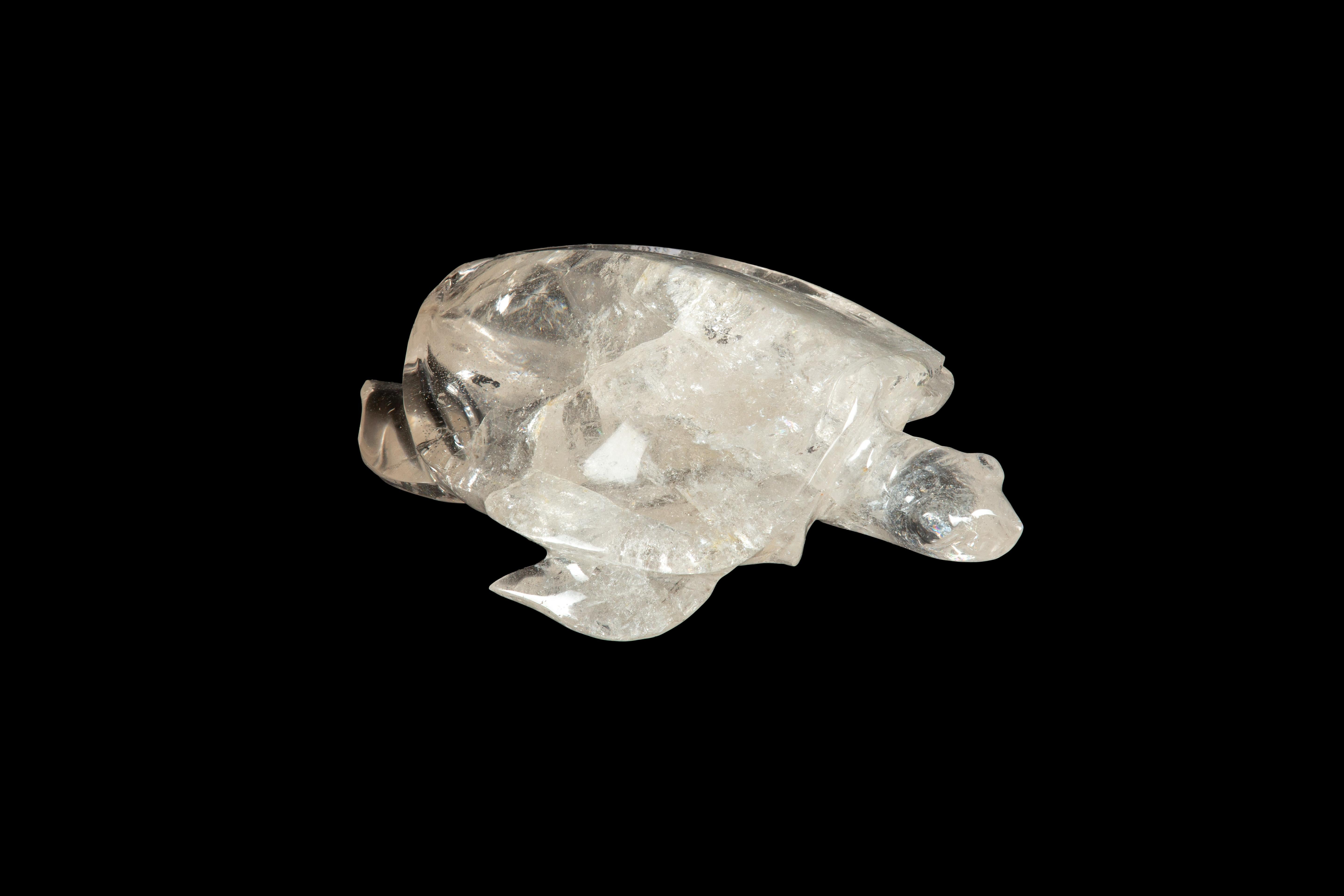 This Large Hand Carved Rock Crystal Turtle is a stunning piece of craftsmanship that will impress anyone who sees it. The turtle is carved from high-quality rock crystal, a clear and colorless variety of quartz, and its intricate details are carved