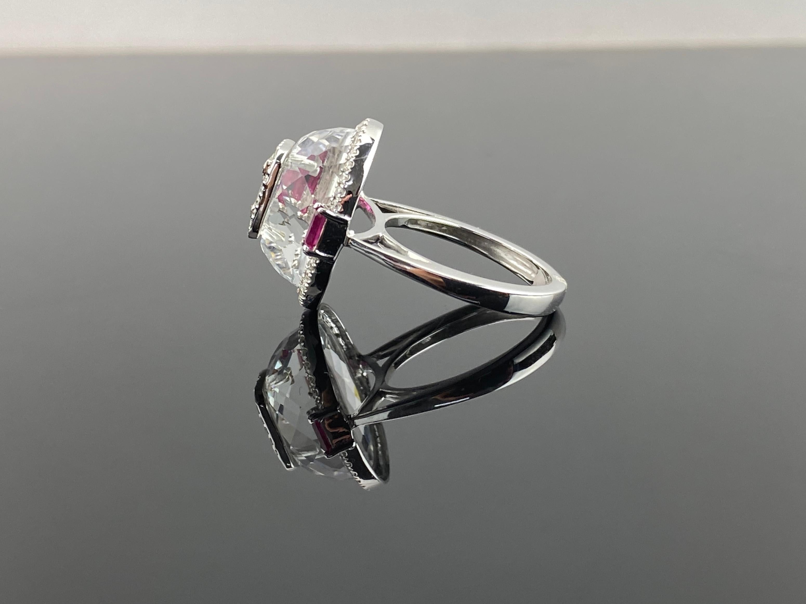 This ring, crafted in 18K white gold, features a faceted cut rock crystal centerpiece, On the top , it has a diamond illusion baguette diamond piece .

The exceptional quality and craftsmanship are evident in every facet. The bright and brilliant