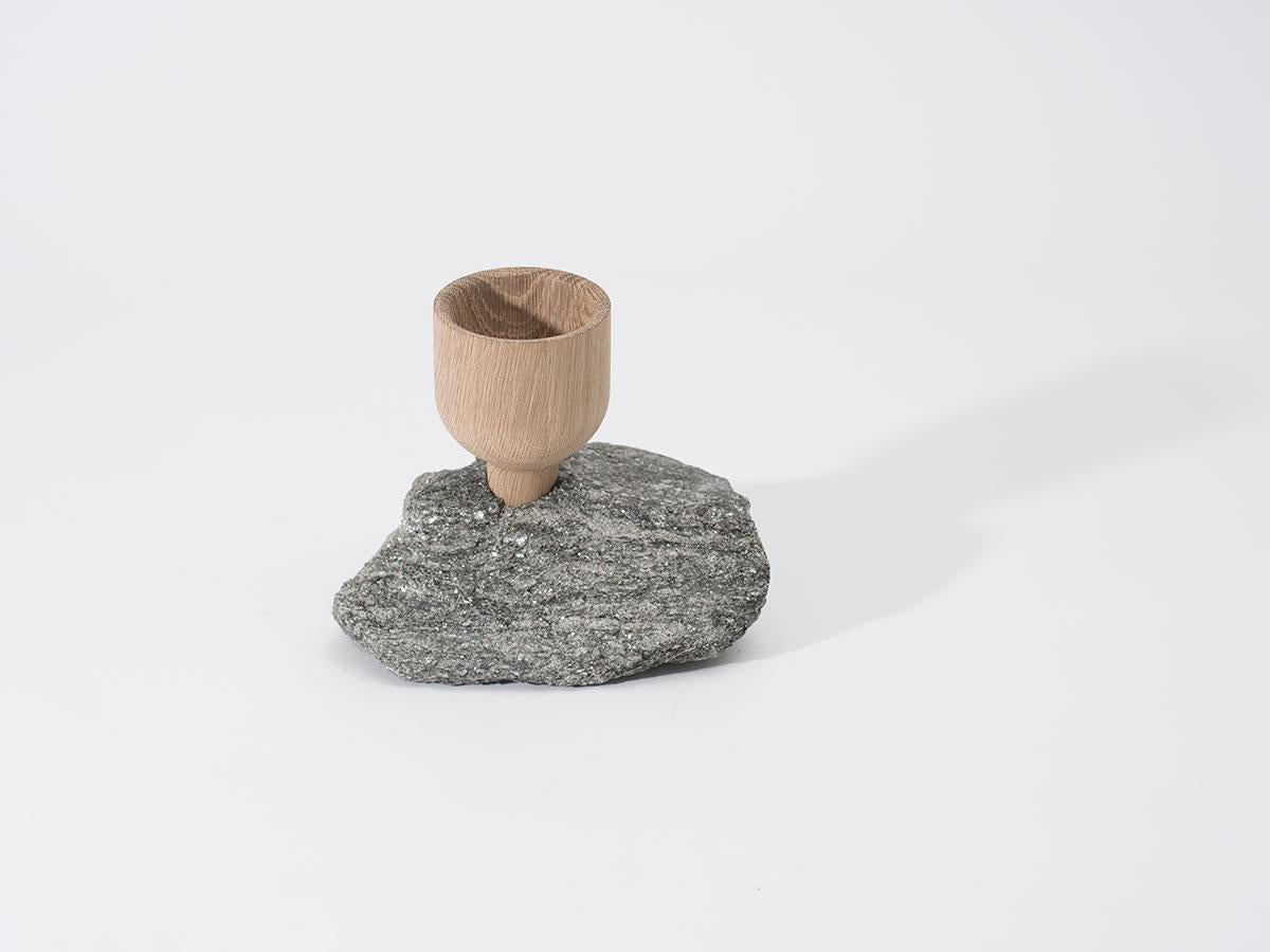 A sculpture made of rock and wood. A mix of natural materials in a refined and raw state. Hand-turned white oak 