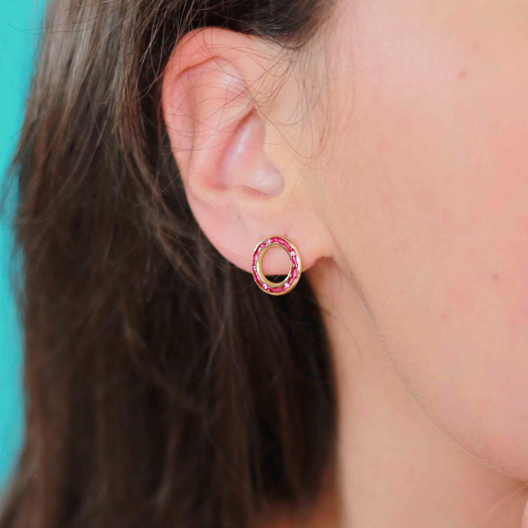 Transport yourself back to the carefree days of childhood beach adventures with these captivating fuchsia pink sapphire stud earrings. With their vivid hues reminiscent of the vibrant rock pools, these circle studs inject a playful pop of color that