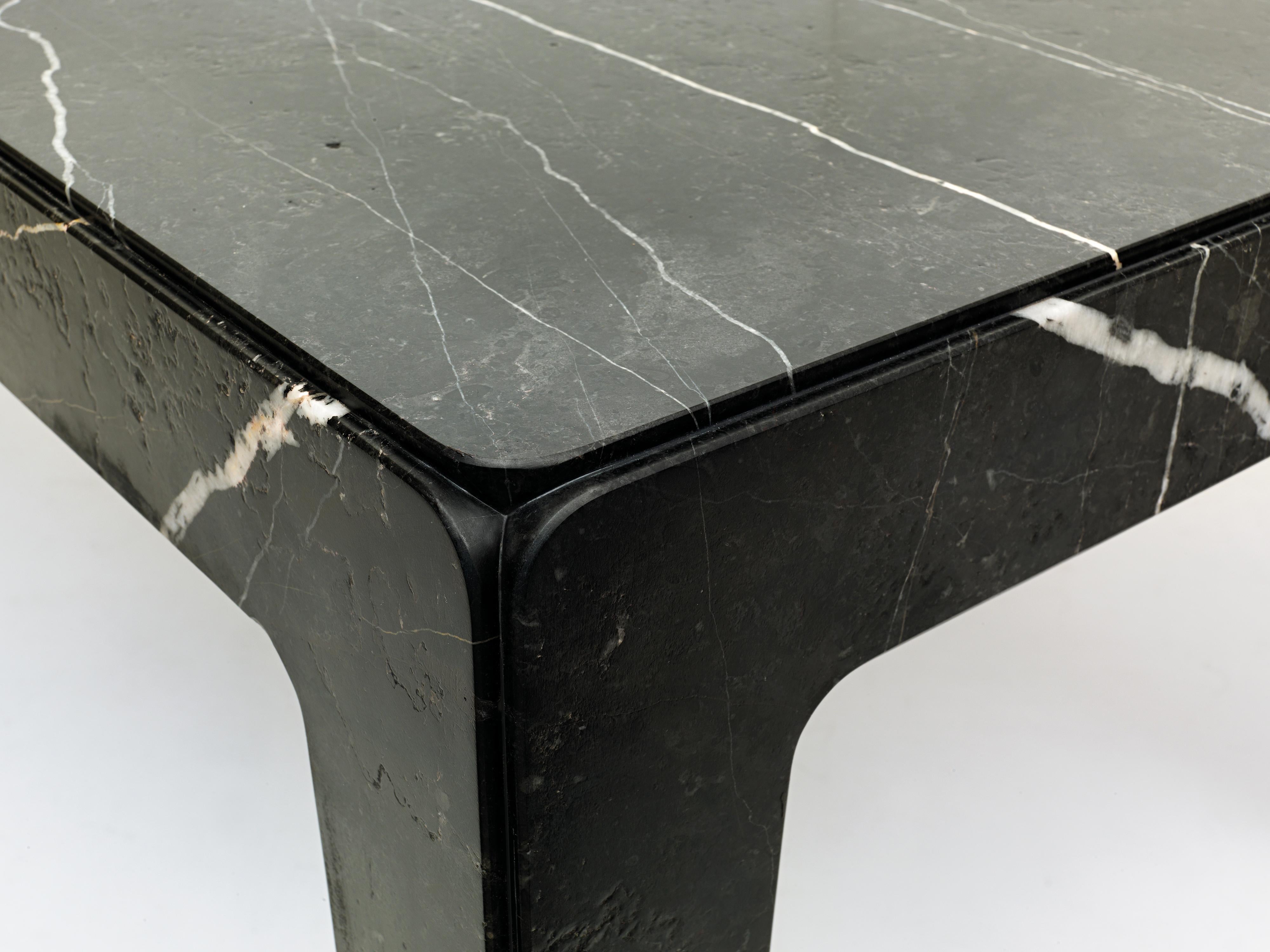 A 4-legged table completely made of stone. Through a simple trick the table, which is in fact the assembly of five parts, appears sculpted from a solid block. The four lateral elements, once they are assembled with the top, become structural without