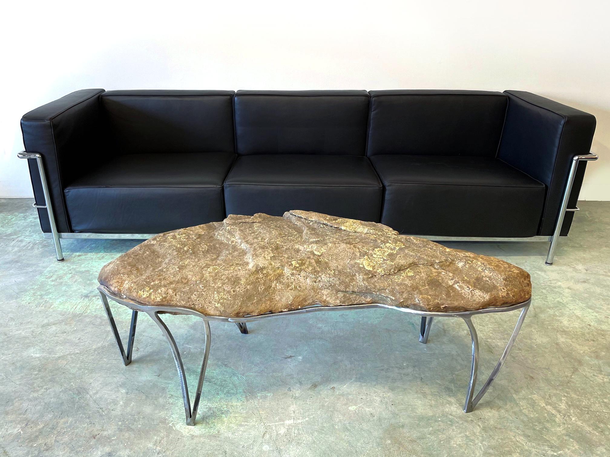 Experience the beauty of nature and the precision of Craft with this stunning coffee table crafted by Quinn Morrissette. Made from steel and natural stone, this table exemplifies the artist's mantra of 