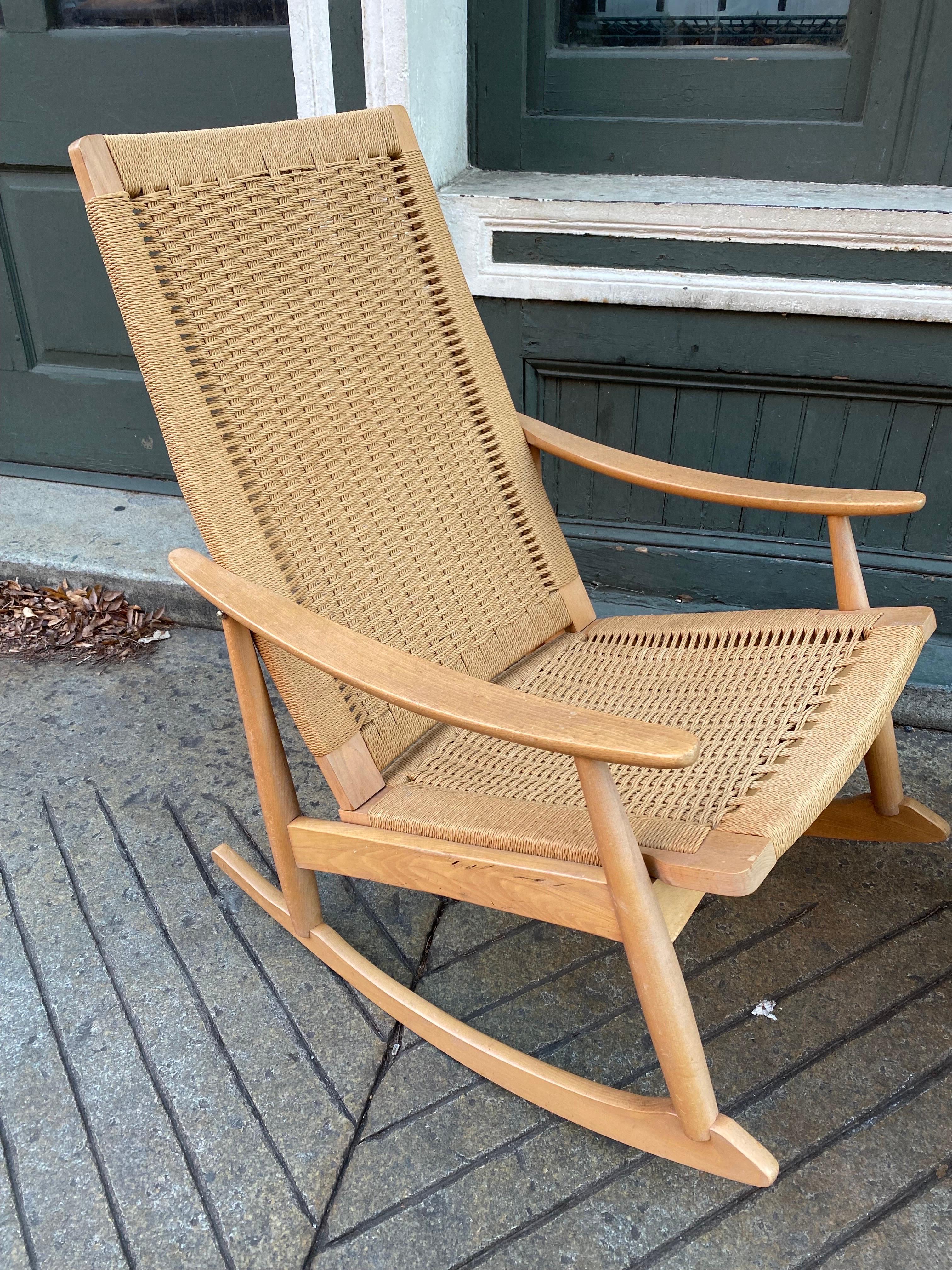 Beautiful, modern oak rocker with roped seat and back. Sold with its matching ottoman. The rope seat and back is woven in a beautiful modern and soft texture. Manufactured in Japan (marking on bottom of frame). Very soft and comfortable as a rocking