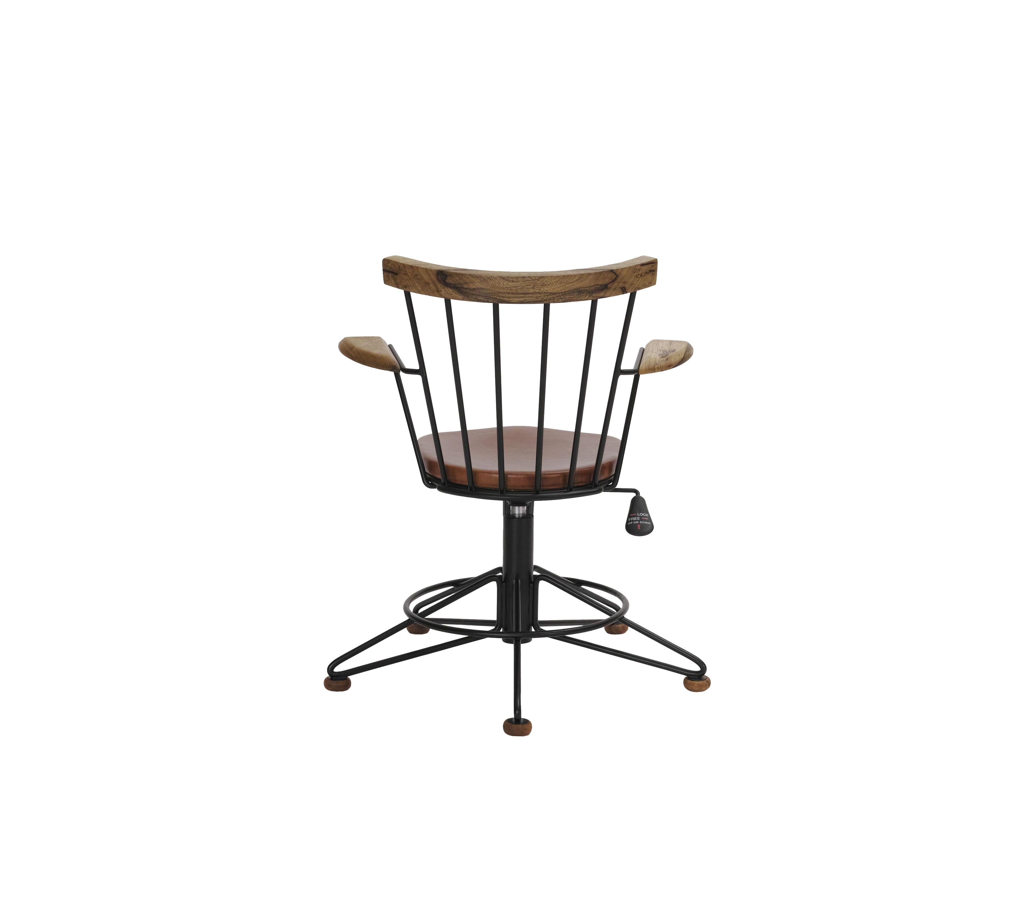 The Rocket Chairs is an industrial desk chair that combines a solid steel frame with solid wooden feet, arched wooden back, wooden elbow support, and a shaped solid wood leather-upholstered padded seat, all supported on a hand bent solid steel
