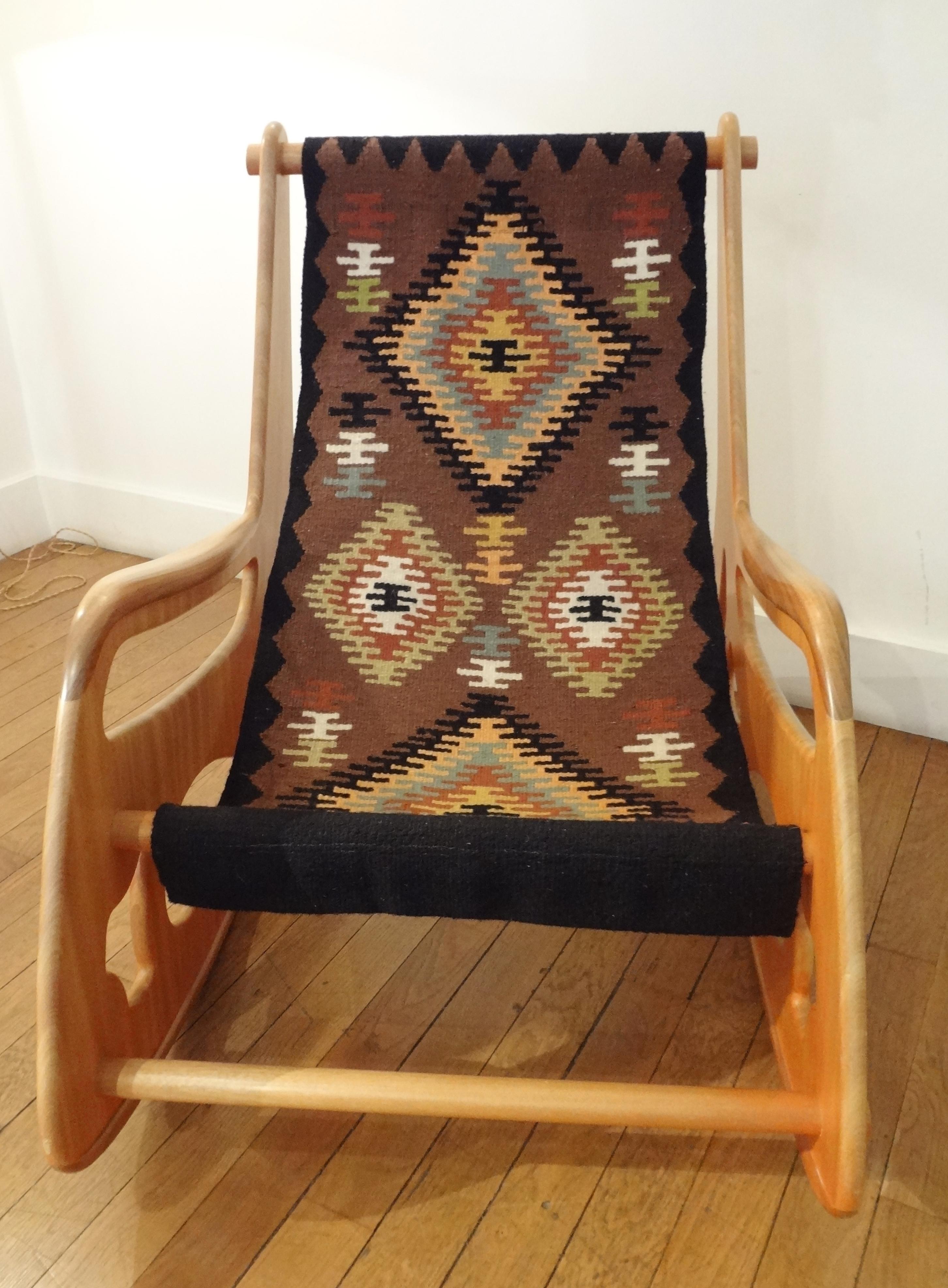 Apostolos Porsanidis, France.
Large wood rocking armchair, 2009
With teck and exotic wood sculpted open sides and Kilim wool tapestry seating.
Measures: Height 35.5 x width 27.5 x depth 42 inches.
With its original small scale model.
Apostolos