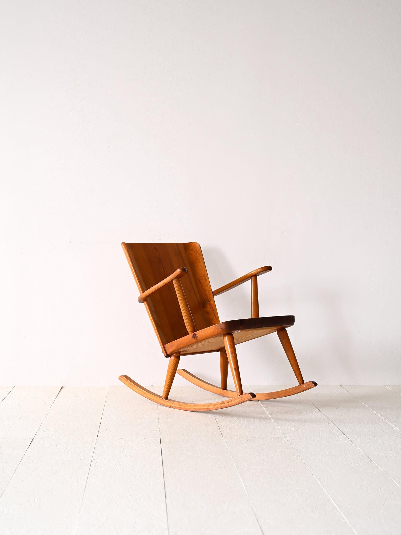 Pine wood rocking chair with armrests.

A Swedish design piece that is part of the Svensk Fur range, a type of pine furniture designed specifically for Swedish summer homes in the late 1930s and 1940s.
An original, solid wood chair model