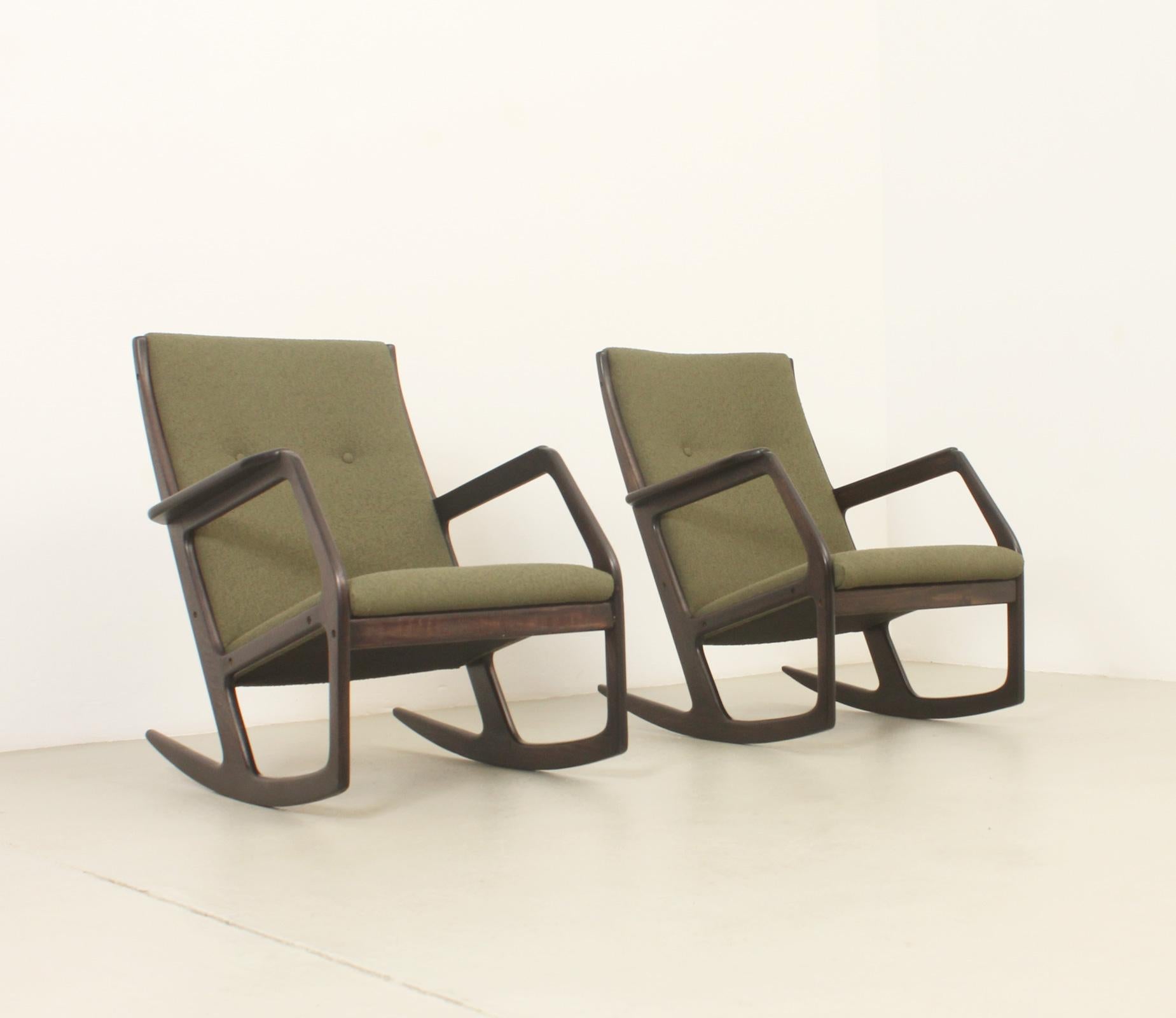 Rocking chair model 100 designed in 1960's by Holger George Jensen for Kubus, Denmark. Ebonized maple wood and new upholstery with bouclé fabric. An invisible counterweight under the seat allows for a more defined rocking motion. 

A pair available.