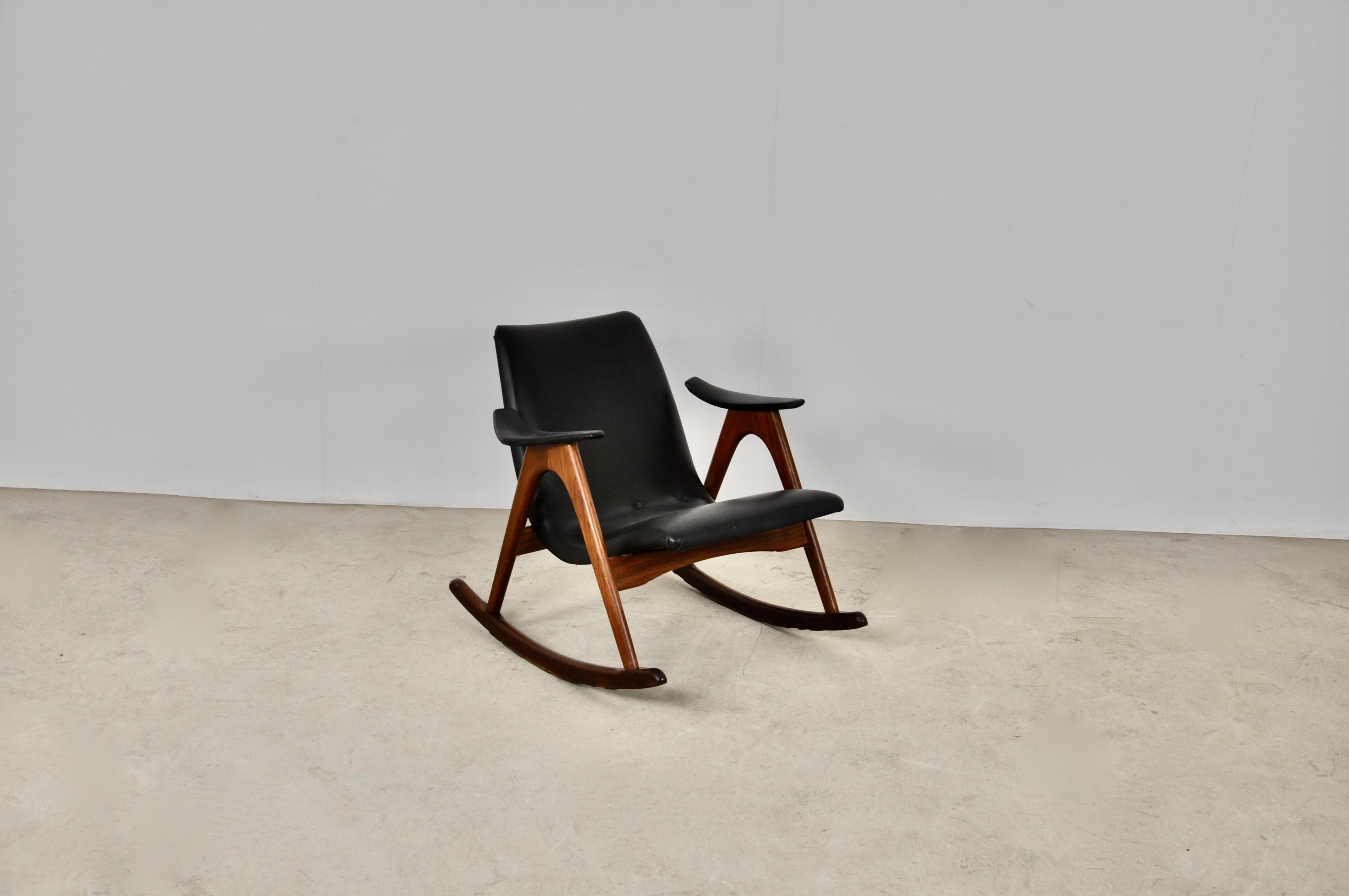 Rocking chair wood color black. Wear due to time and age of rocking chair.